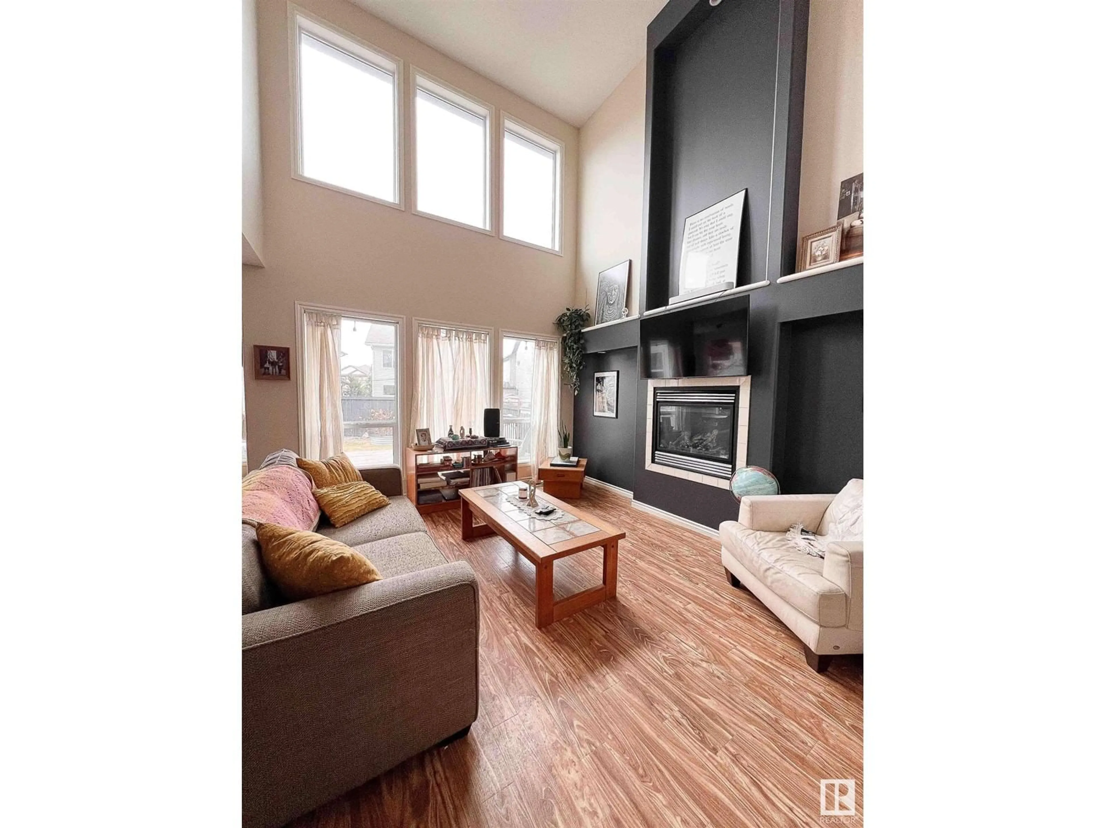 Living room with furniture, wood/laminate floor for 5 BAIE MADELENE, Beaumont Alberta T4X0E8