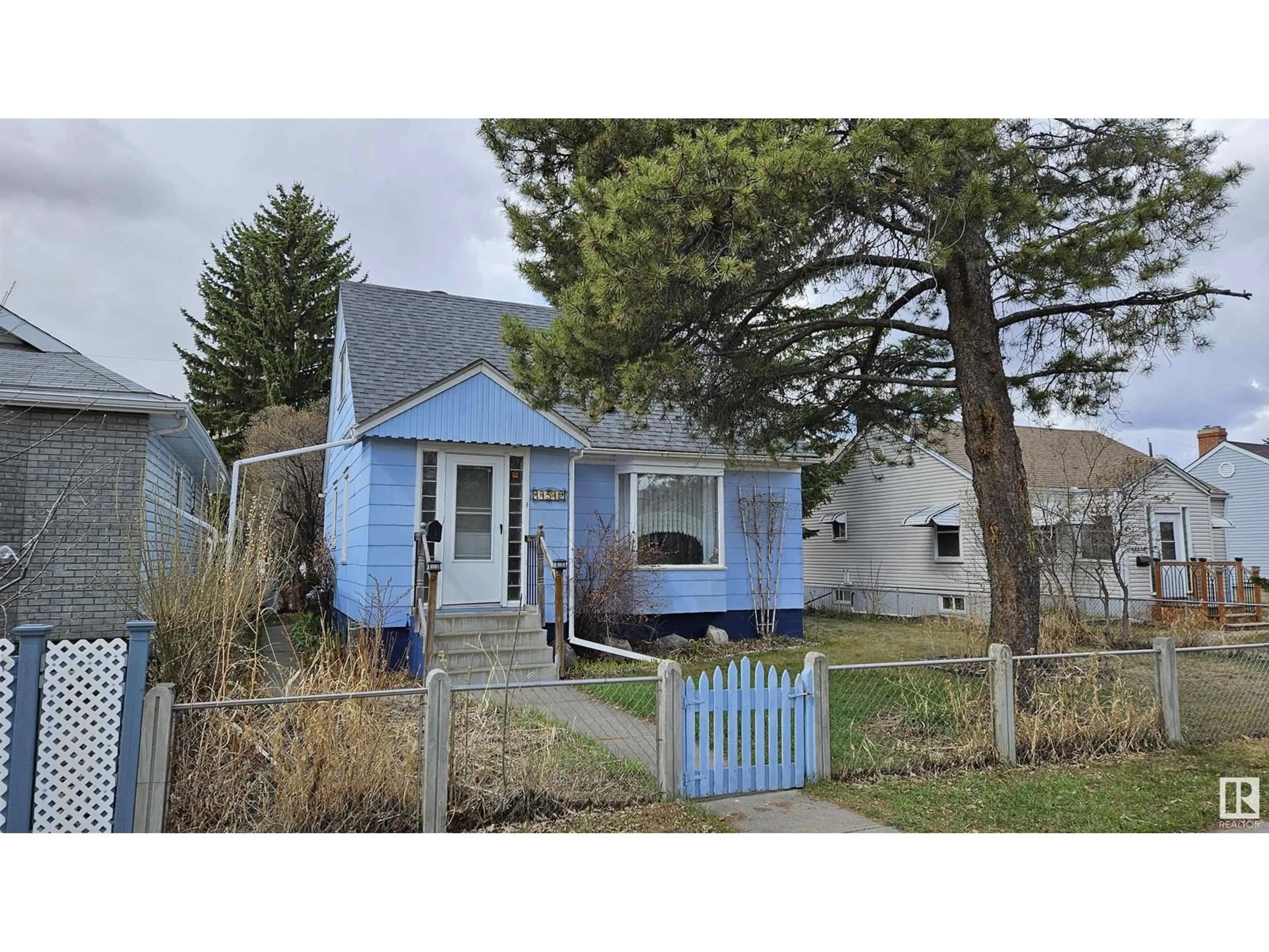 Home with vinyl exterior material, street for 11512 86 ST, Edmonton Alberta T5B3J5