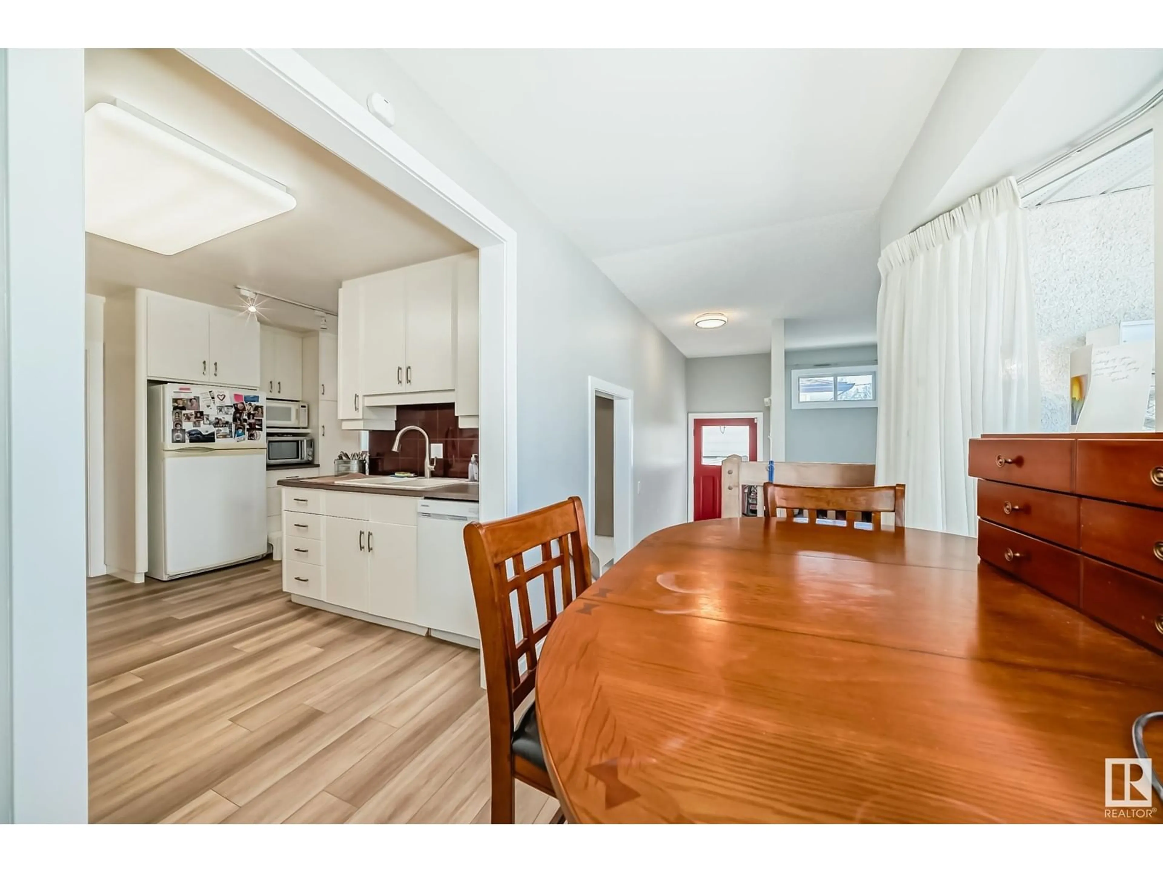 Open concept kitchen, wood/laminate floor for 11632 48 AV, Edmonton Alberta T6H0E6