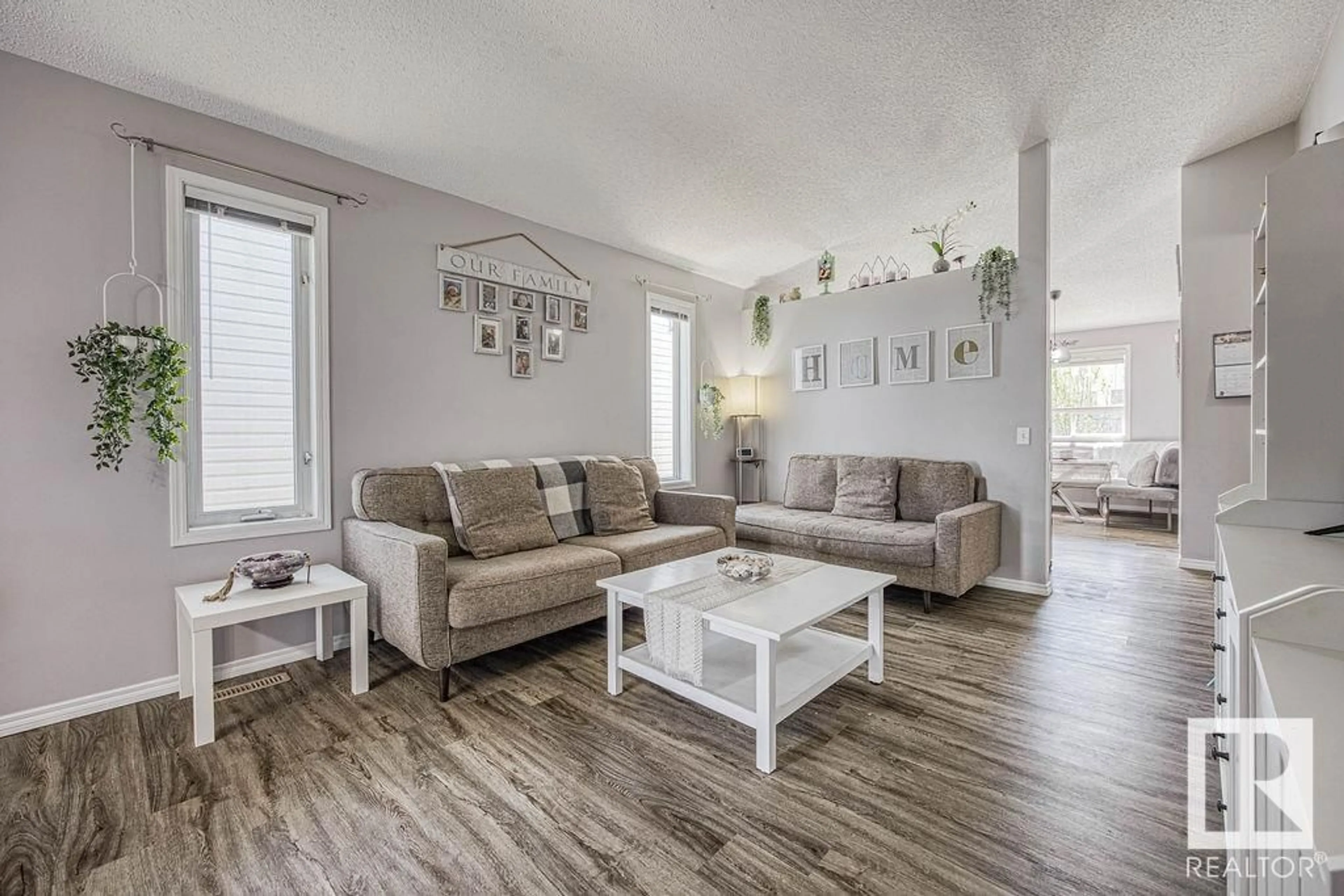 Living room with furniture, wood/laminate floor for 8315 170 AV, Edmonton Alberta T5Z3G8