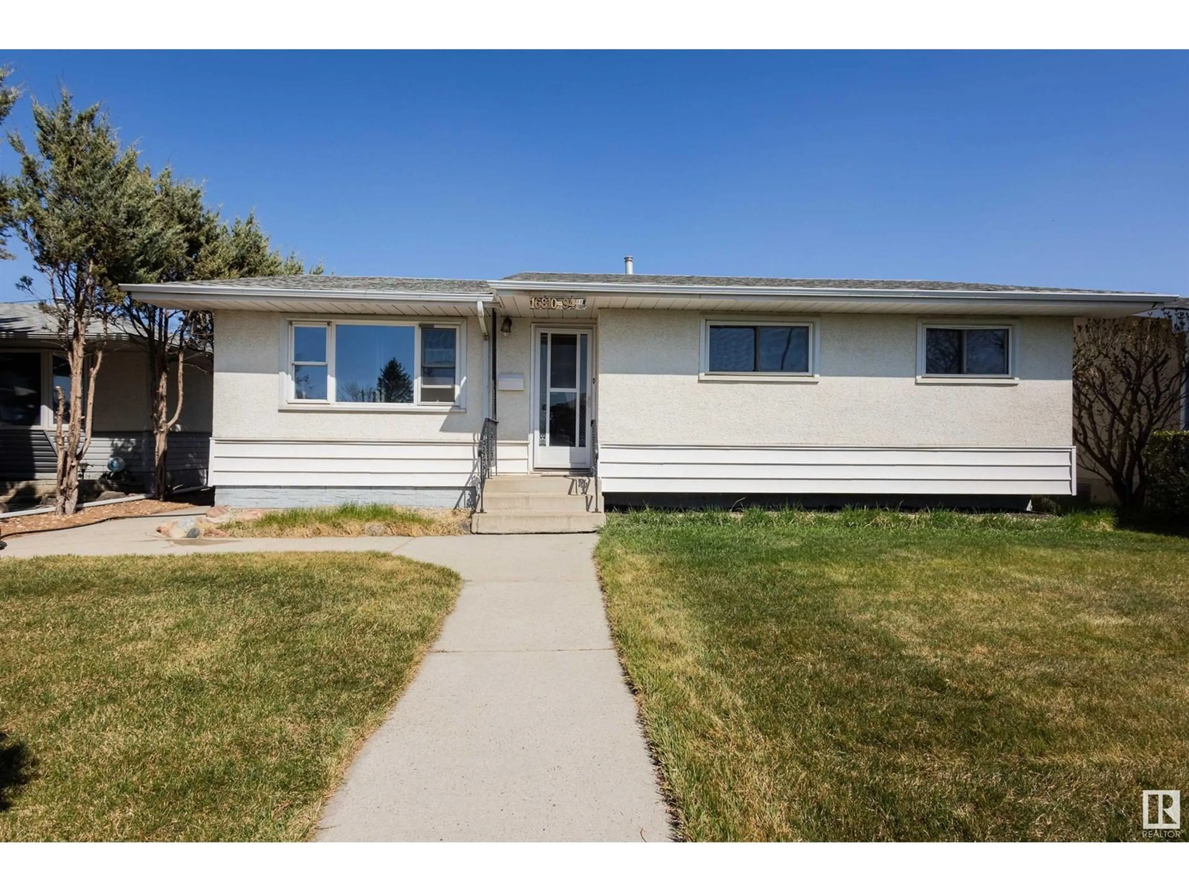 Home with vinyl exterior material, street for 16810 94 AV, Edmonton Alberta T5R5L5