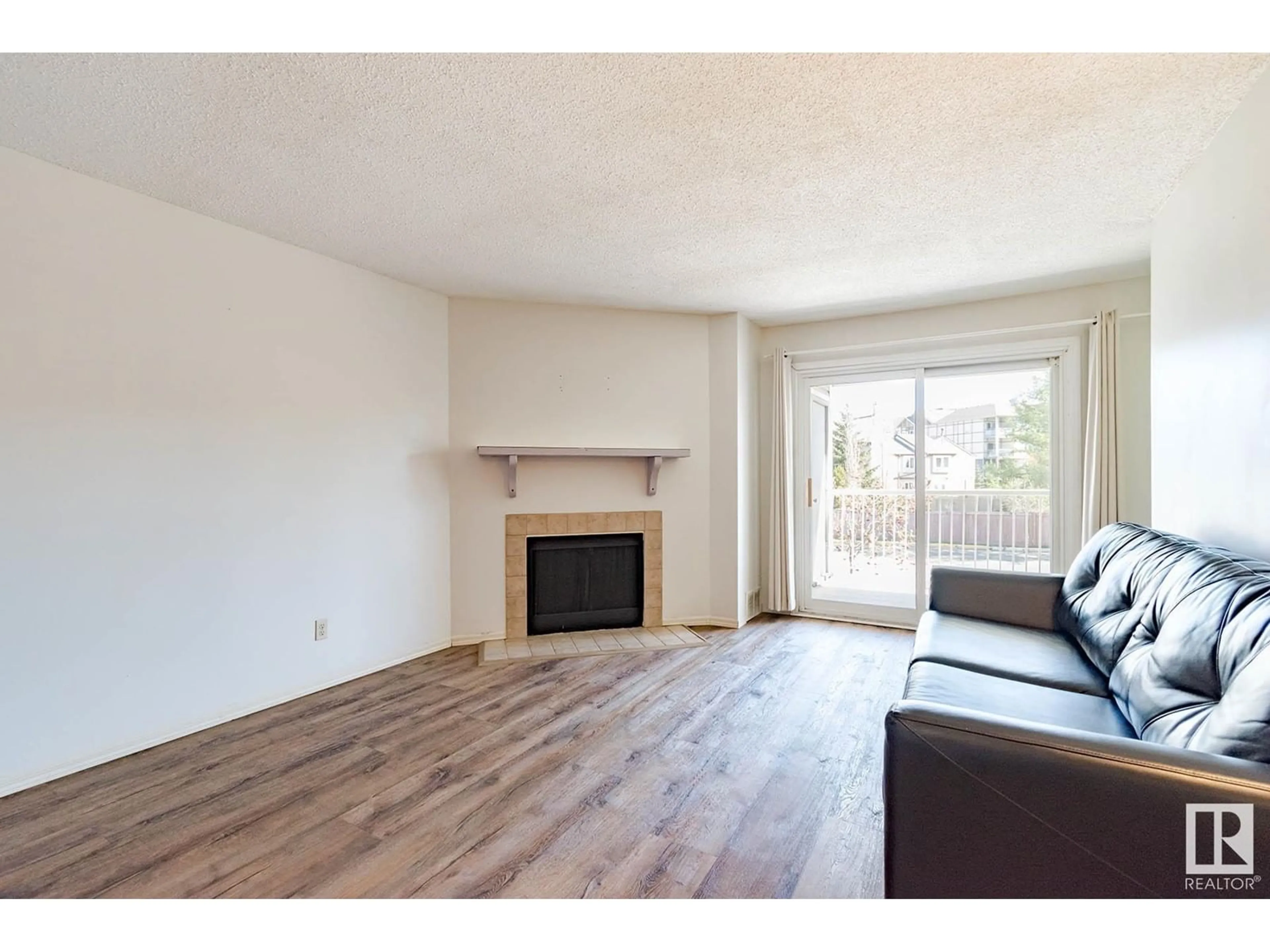 Living room with furniture, wood/laminate floor for #107 - 10404 24 AV, Edmonton Alberta T6J4J7