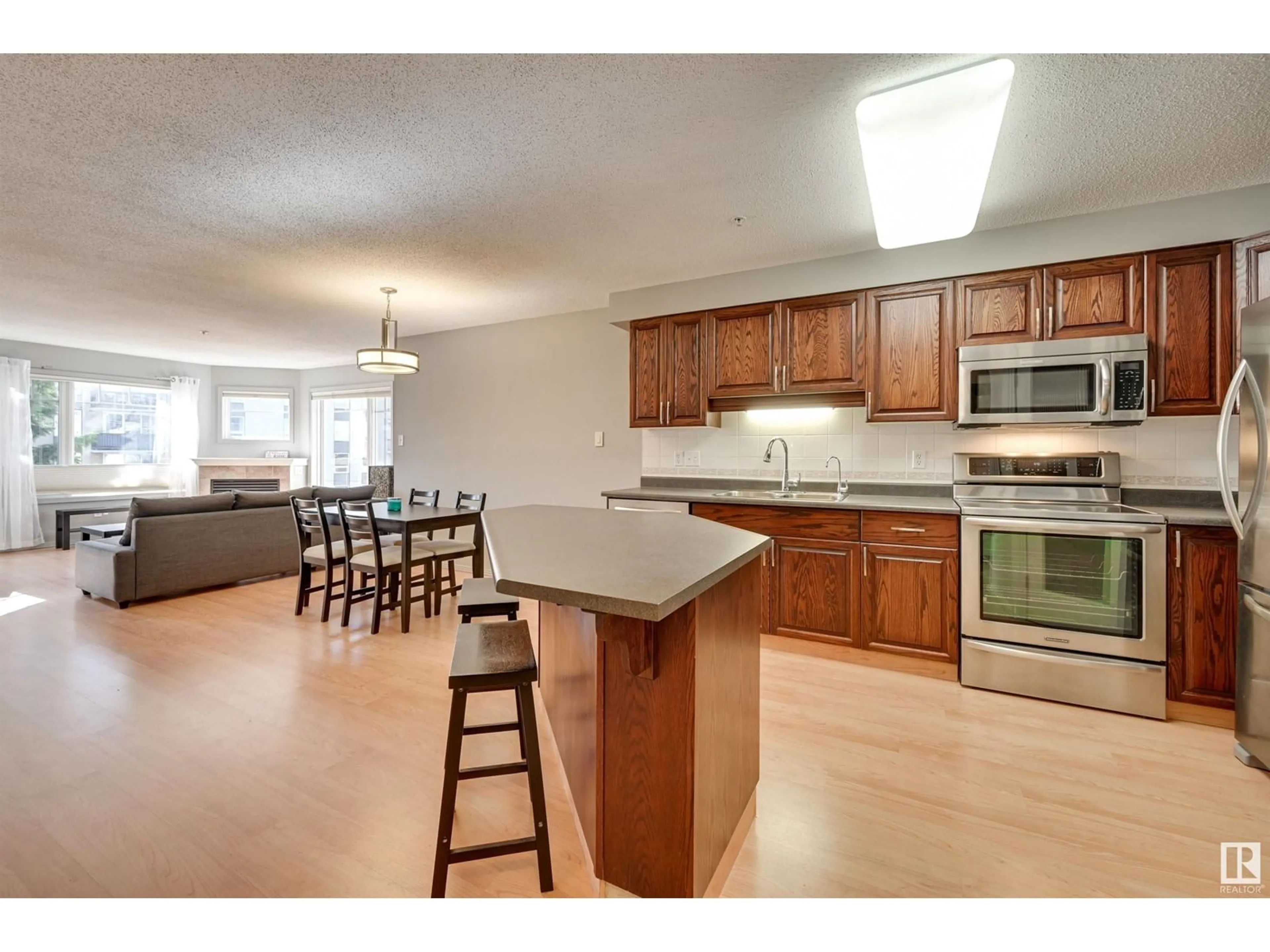 Open concept kitchen, wood/laminate floor for #305 - 8909 100 ST, Edmonton Alberta T6E6T4