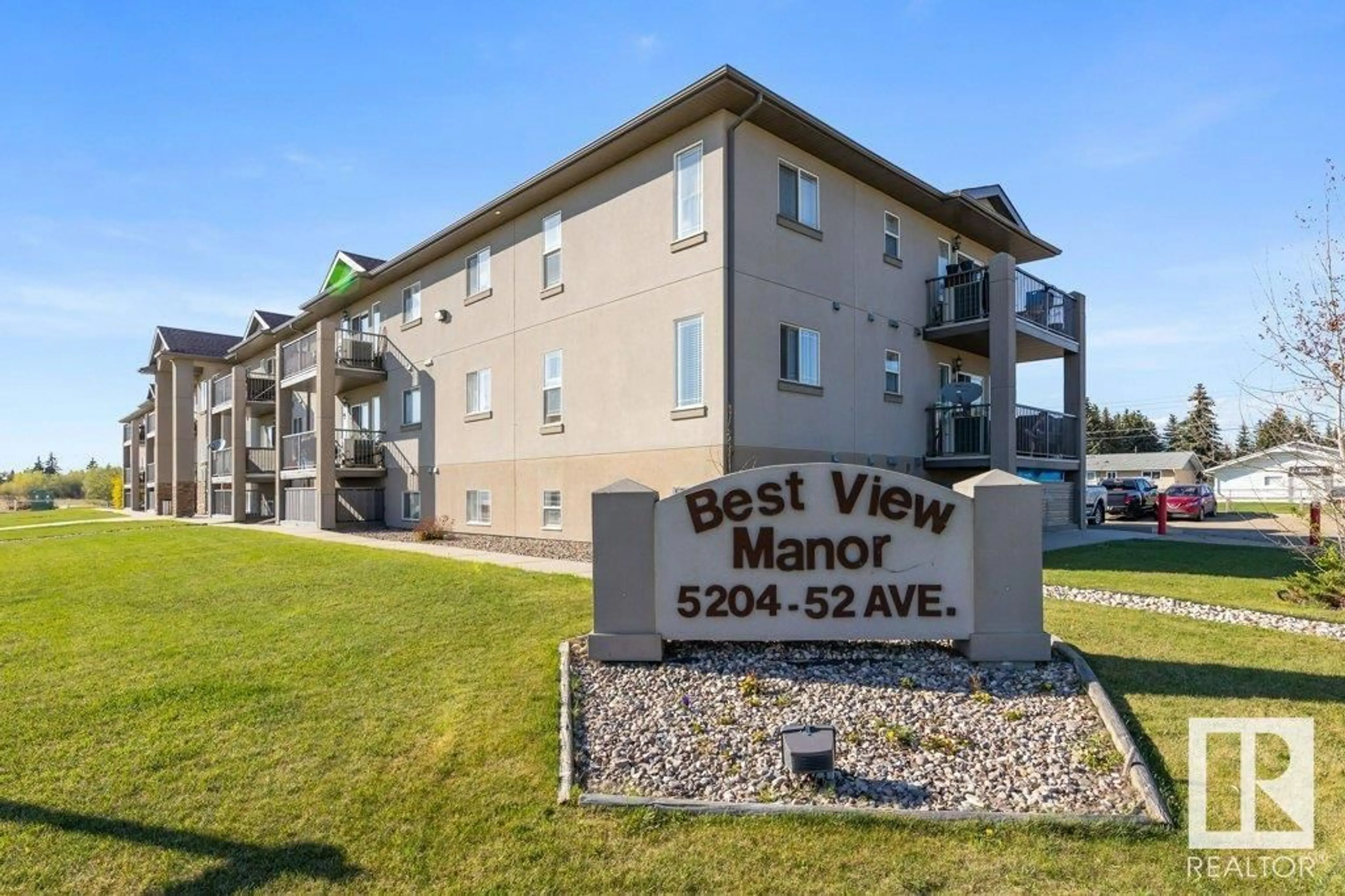 A pic from outside/outdoor area/front of a property/back of a property/a pic from drone, mountain view for 307 - 5204 52 AV, Tofield Alberta T7X4R5