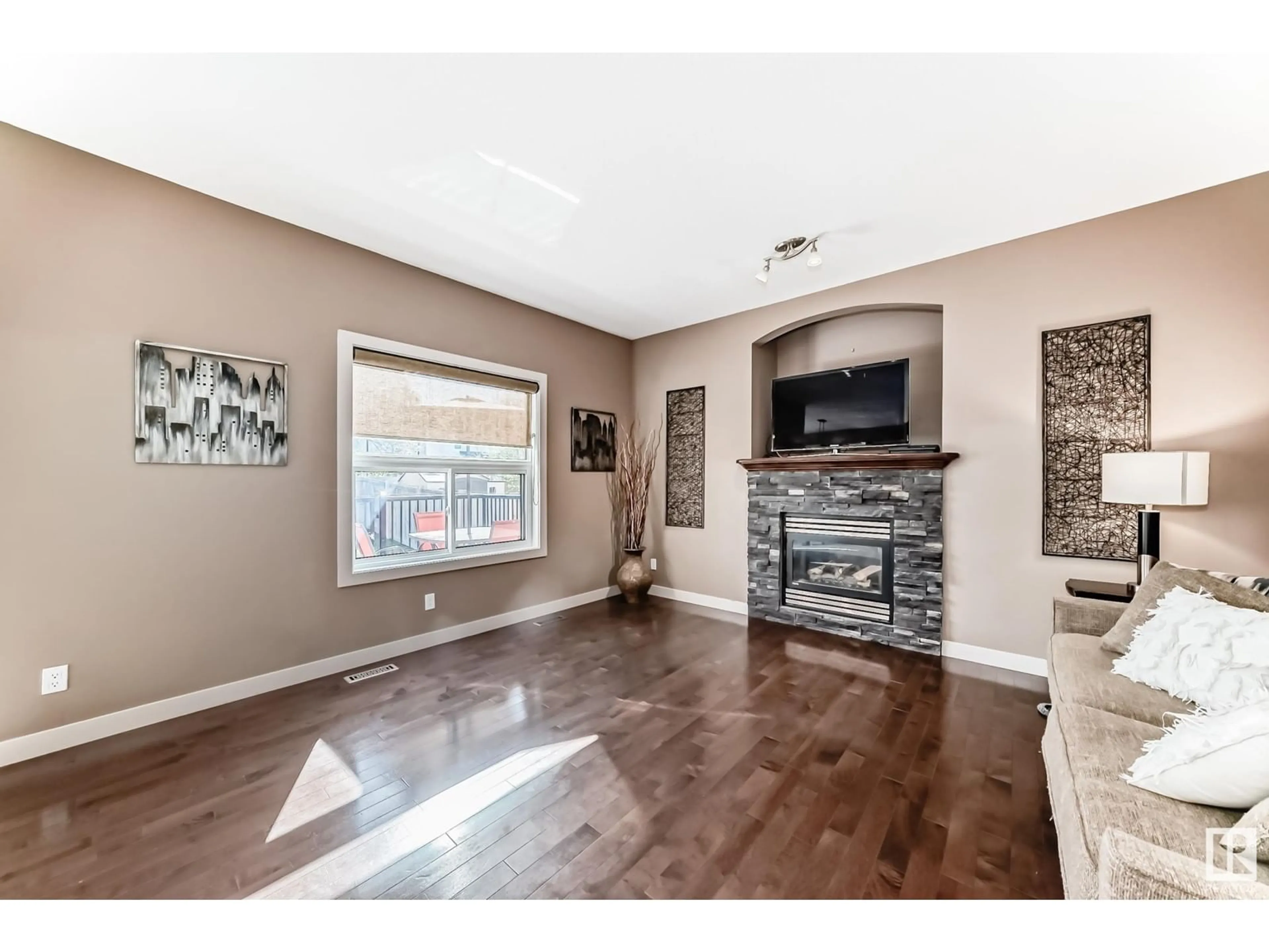 Living room with furniture, wood/laminate floor for 207 SECORD DR, Edmonton Alberta T5T4A7