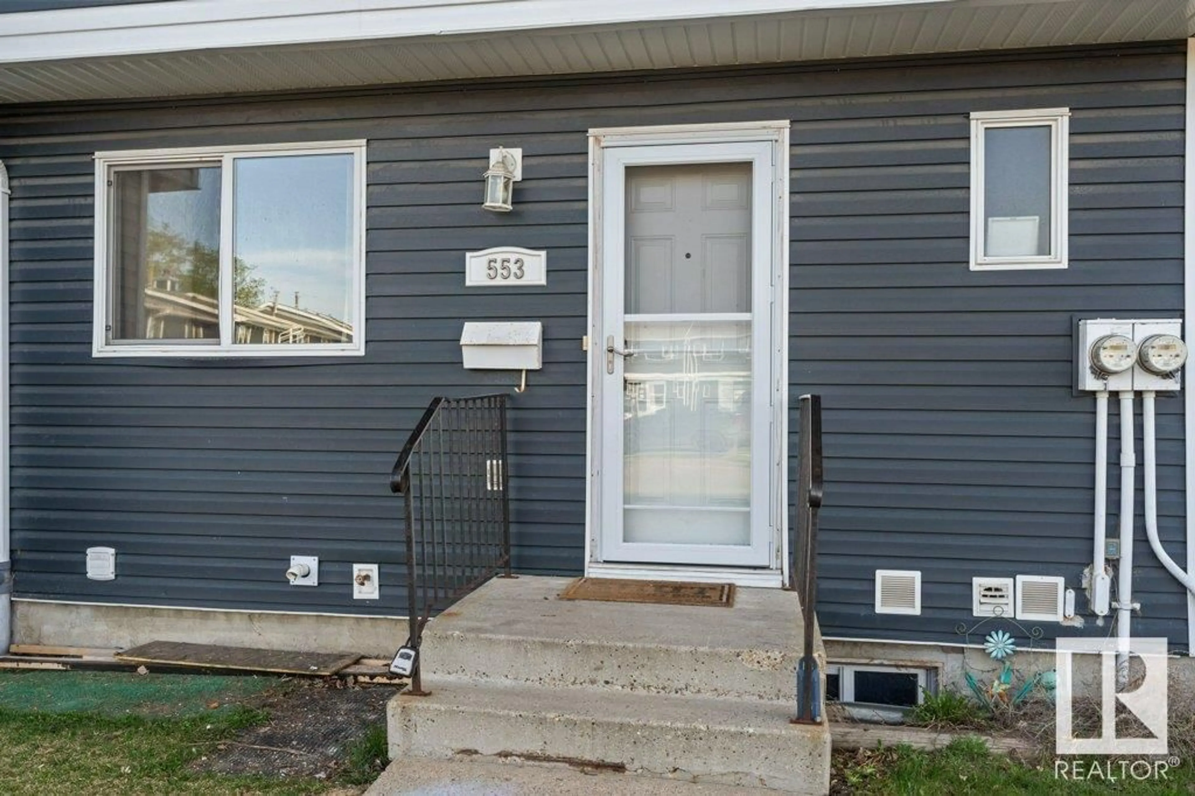 Home with vinyl exterior material, street for 553 DUNLUCE RD, Edmonton Alberta T5X4P4