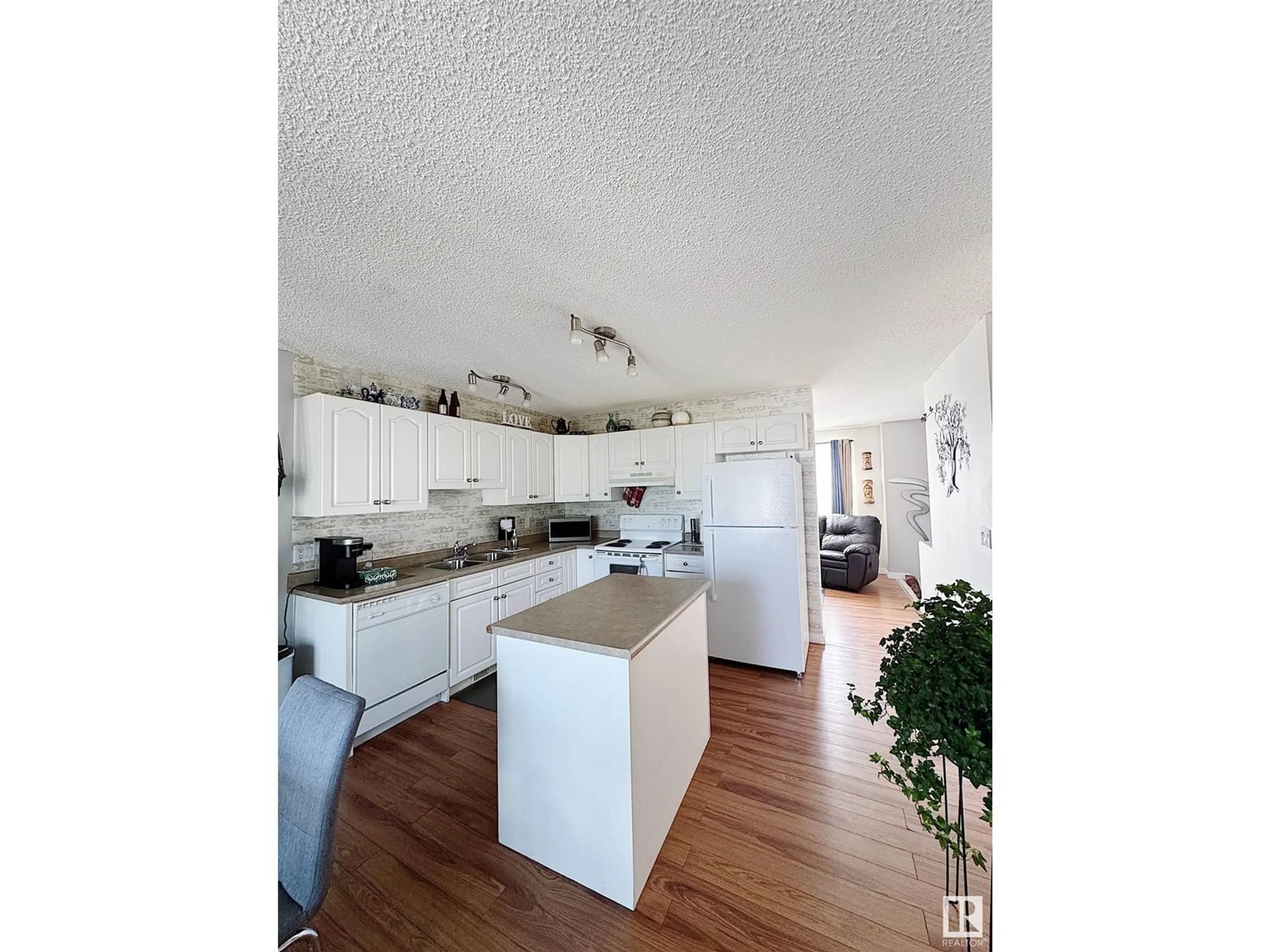 Open concept kitchen, wood/laminate floor for #9 - 16777 91 ST, Edmonton Alberta T5Z3X4