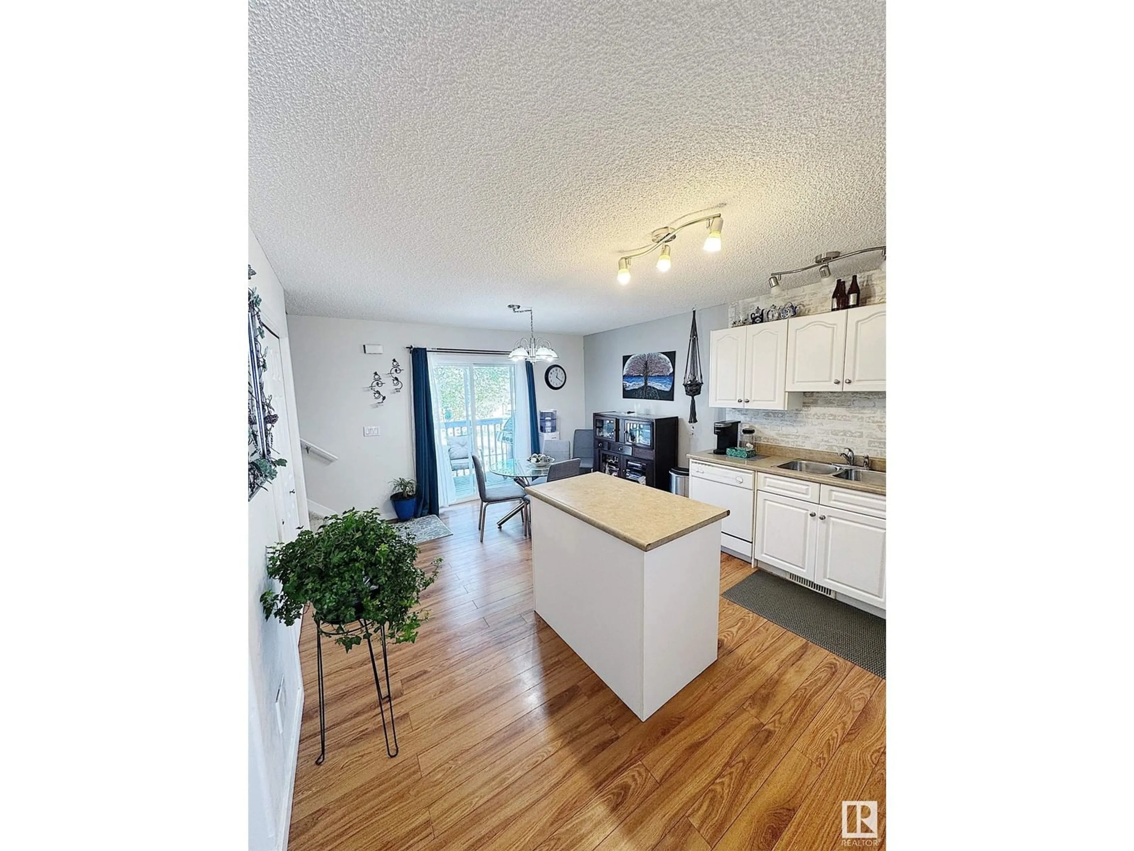 Open concept kitchen, wood/laminate floor for #9 - 16777 91 ST, Edmonton Alberta T5Z3X4