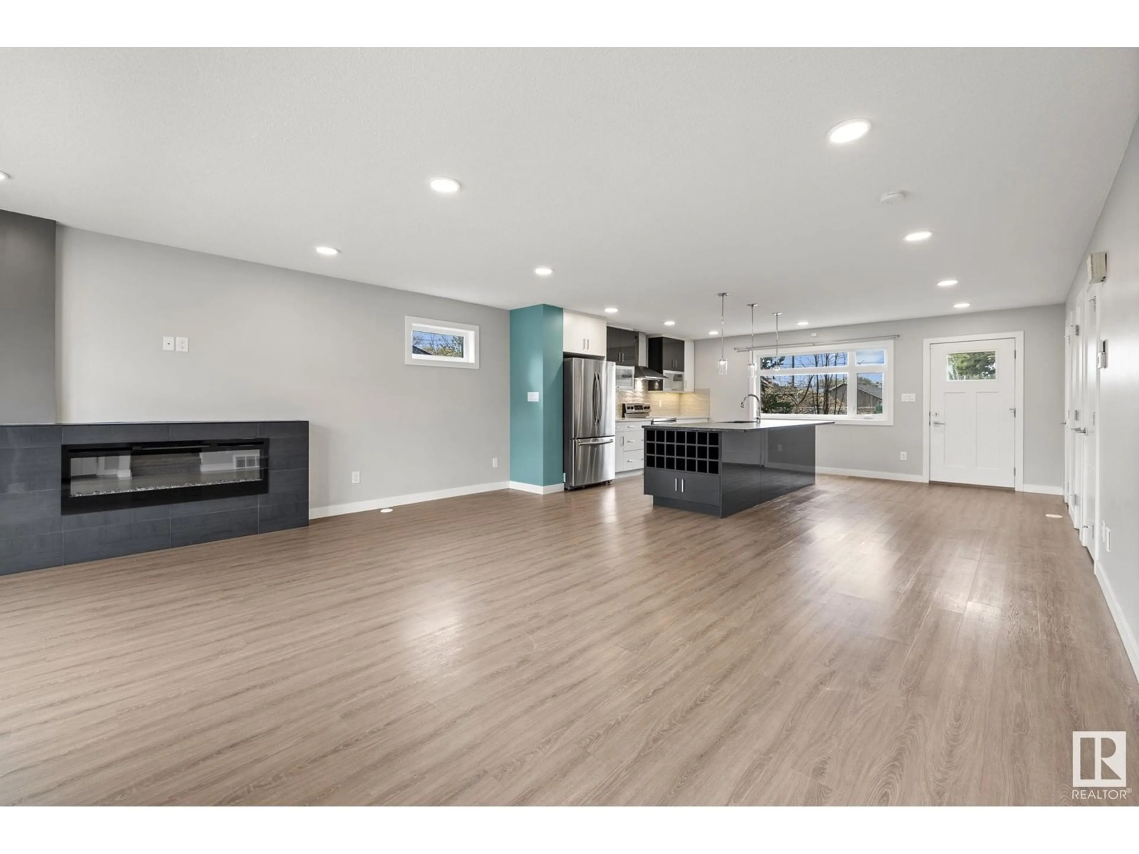 Open concept kitchen, wood/laminate floor for 12208 117 AV, Edmonton Alberta T5M0G8
