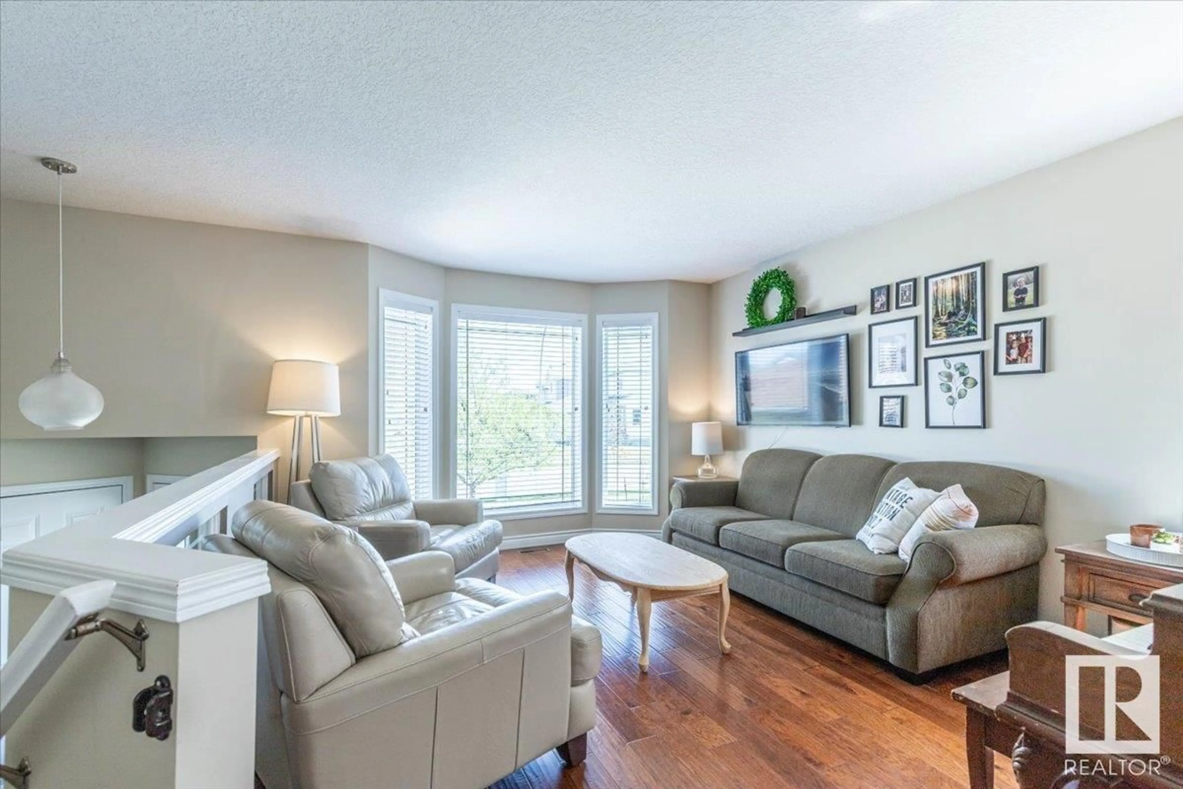 Living room with furniture, wood/laminate floor for 21 MEADOWVIEW DR, Leduc Alberta T9E8E4
