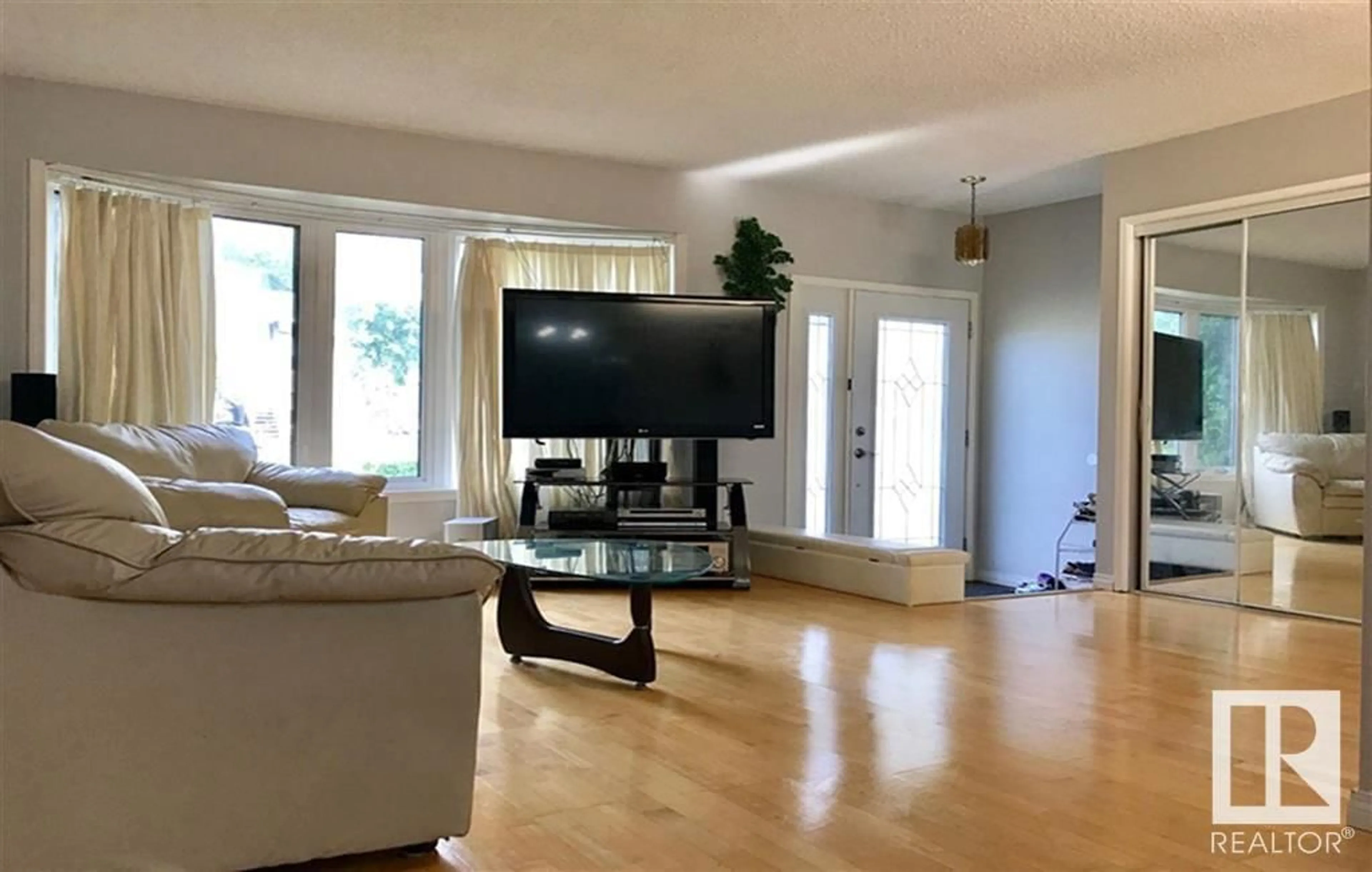 Living room with furniture, wood/laminate floor for 9220 172 ST, Edmonton Alberta T5T3G2