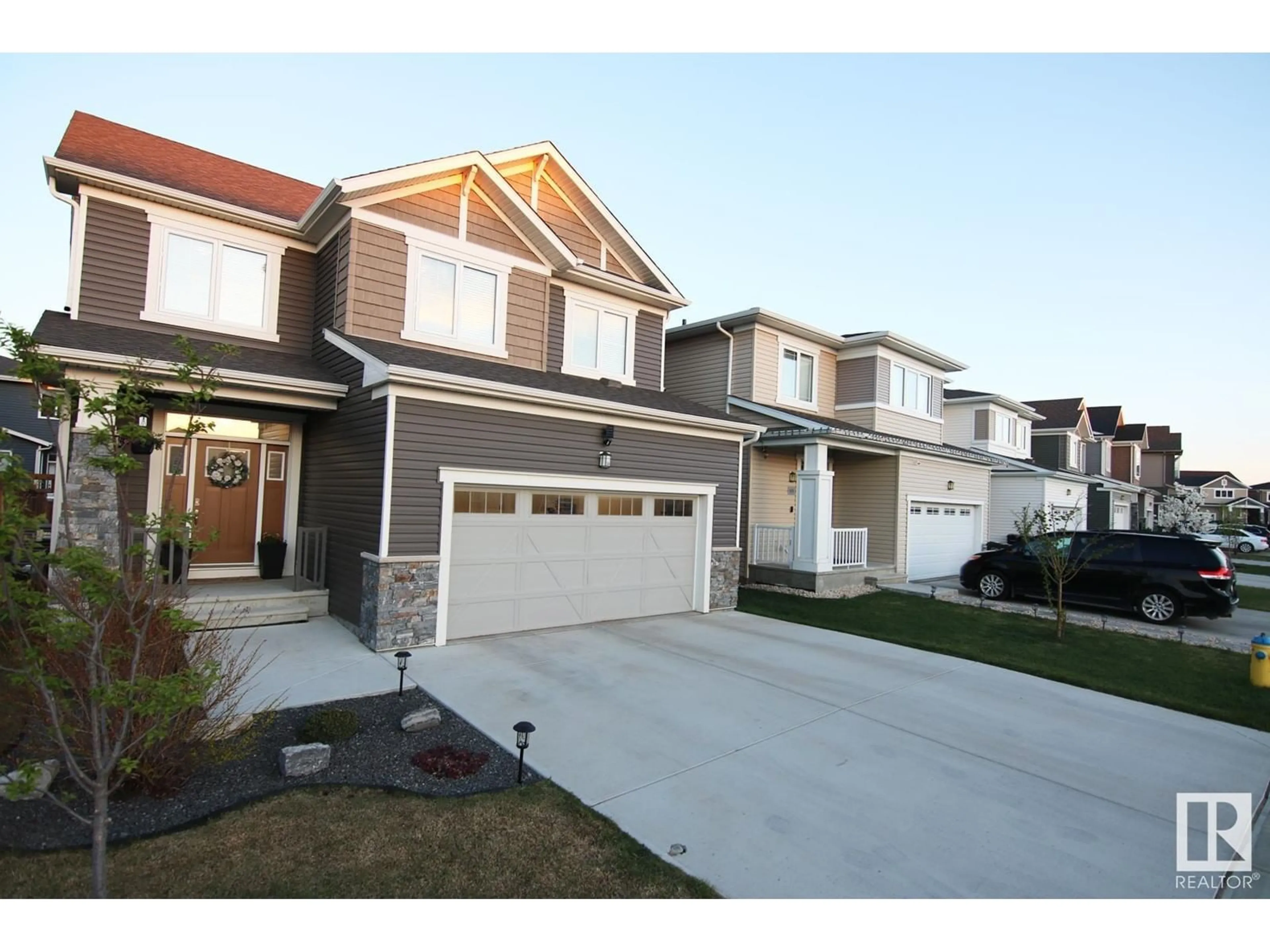 Home with vinyl exterior material, street for NW - 1703 201 ST, Edmonton Alberta T6M0Y1