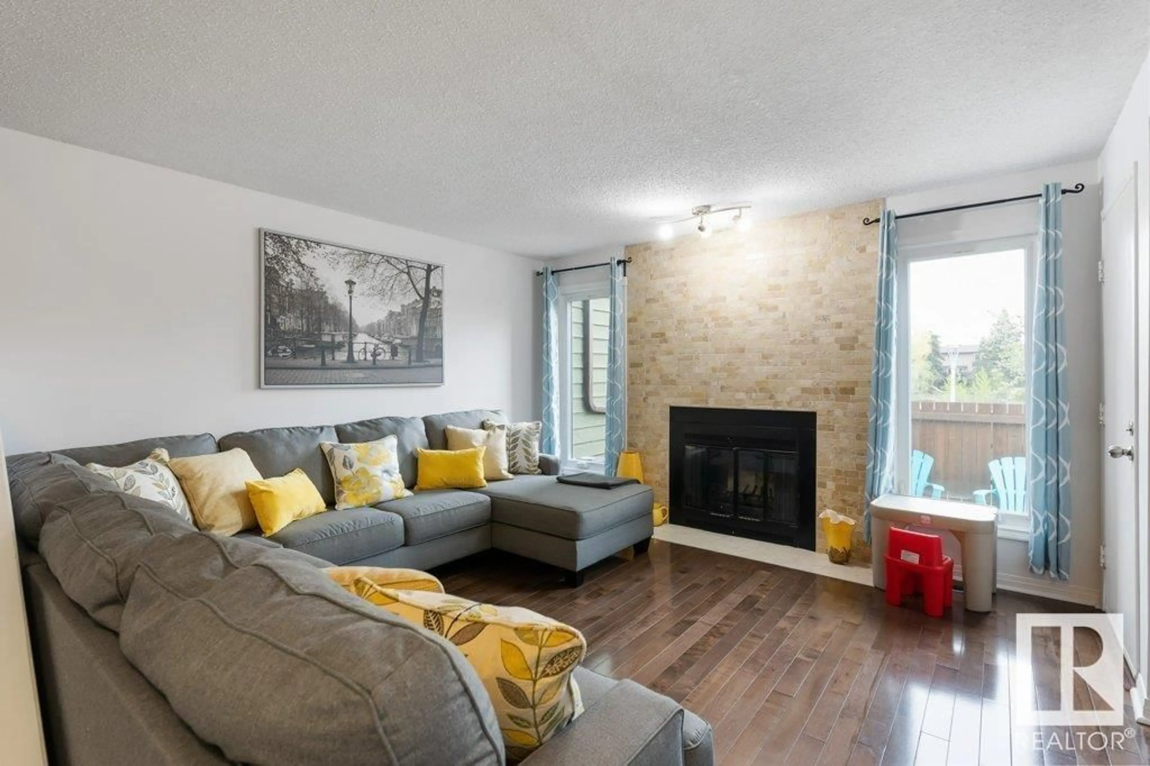 Living room with furniture, wood/laminate floor for 16913 95 ST, Edmonton Alberta T5Z1Z2
