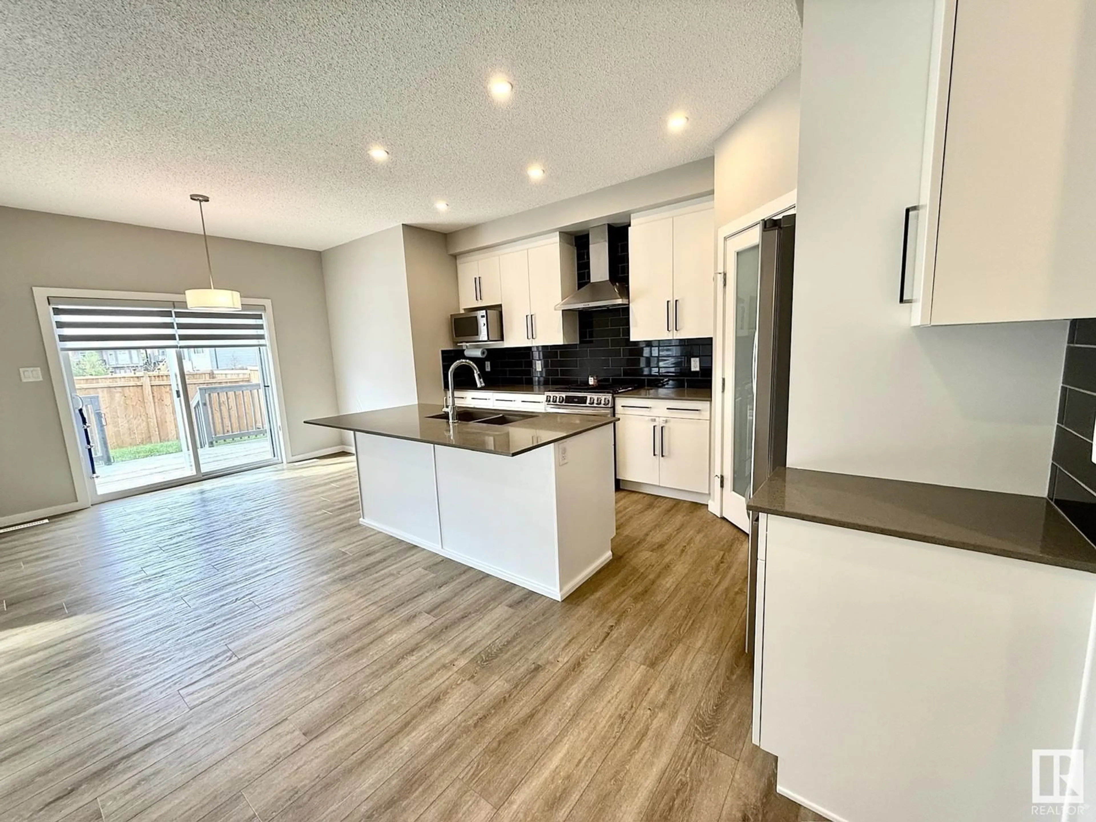 Open concept kitchen, wood/laminate floor for 9015 183 AV, Edmonton Alberta T5Z0S7