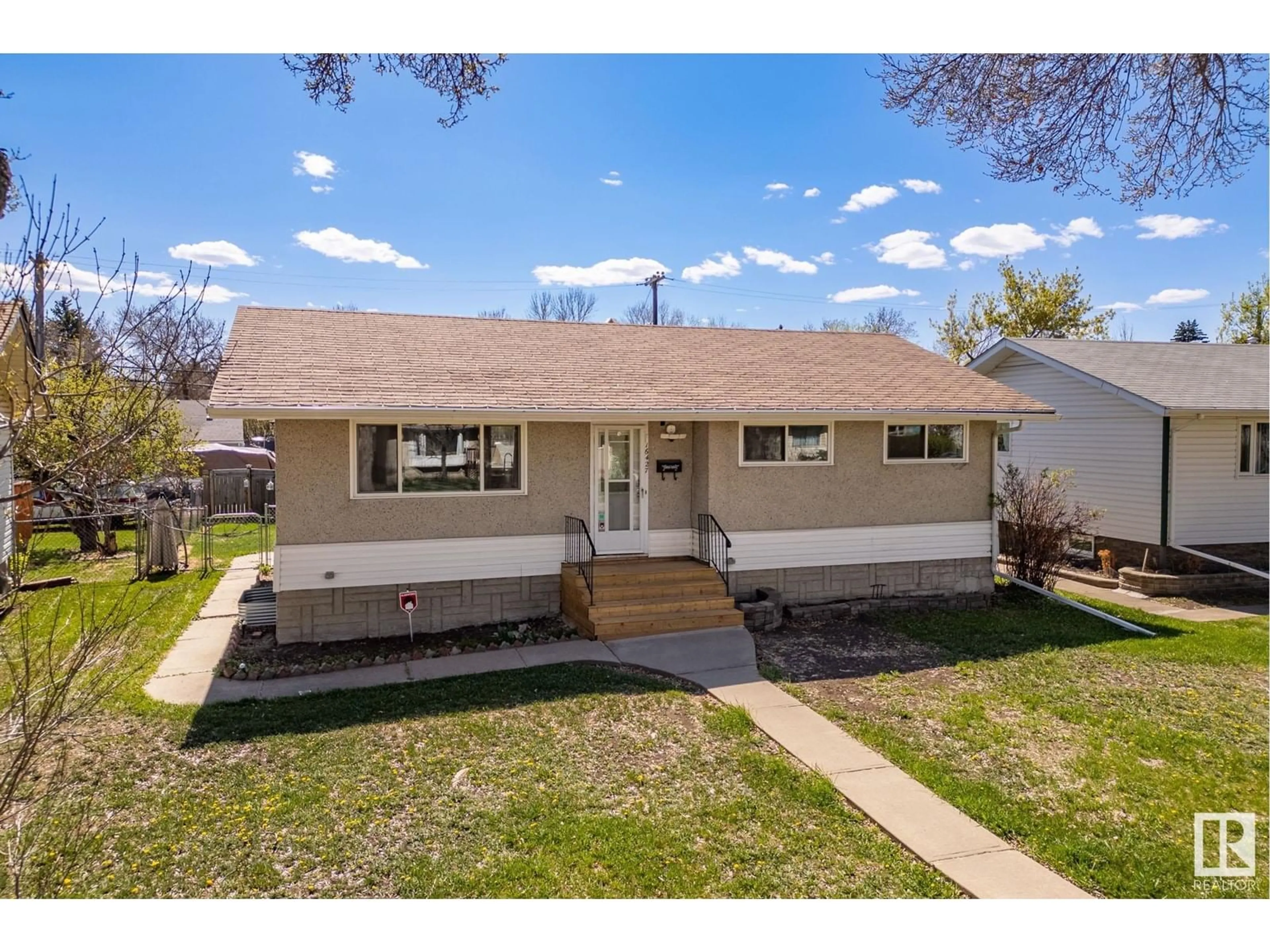 Home with vinyl exterior material, street for 16427 105 AV NW, Edmonton Alberta T5P0V2