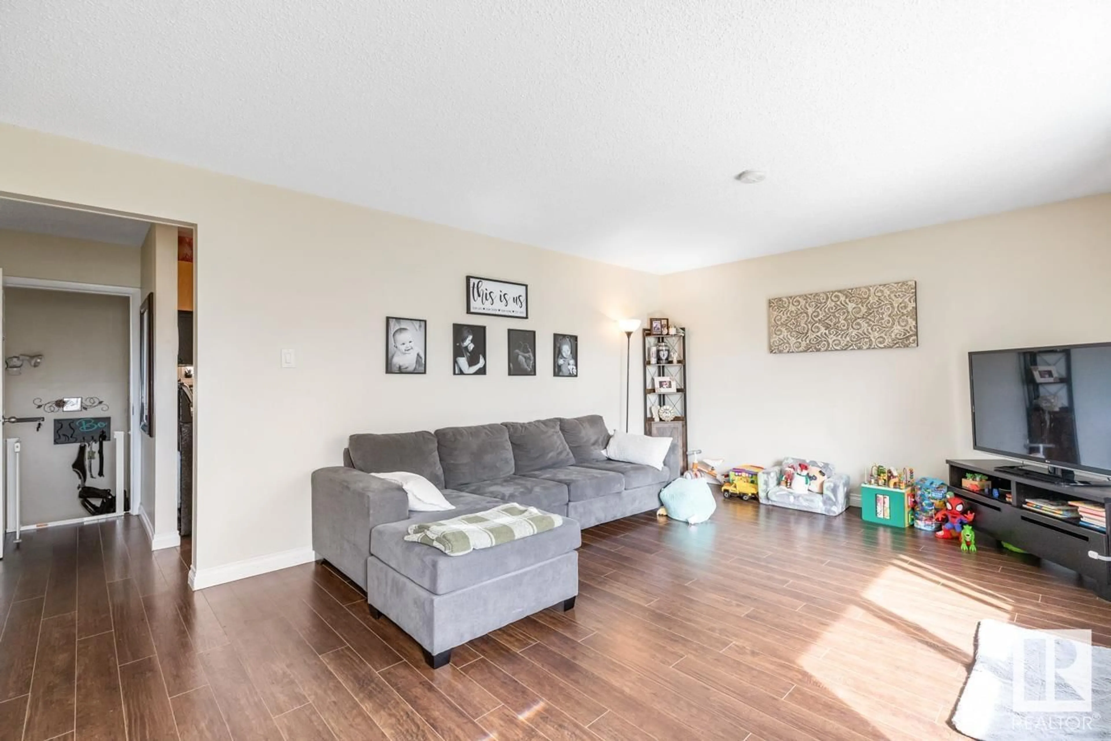 Living room with furniture, wood/laminate floor for NW - 13320 62 ST, Edmonton Alberta T5A0V6