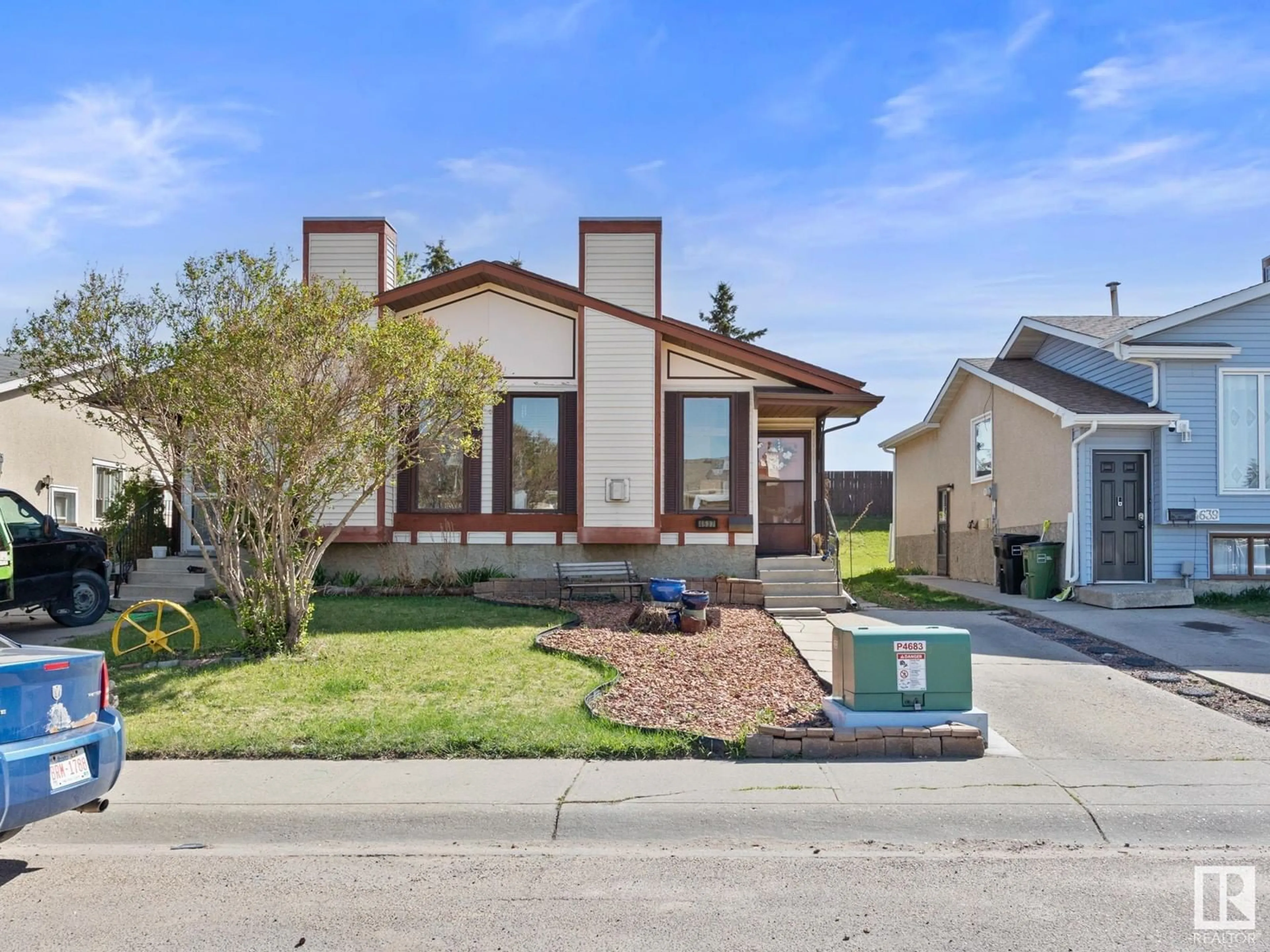 Home with brick exterior material, street for 4637 126 AV, Edmonton Alberta T5A4L1
