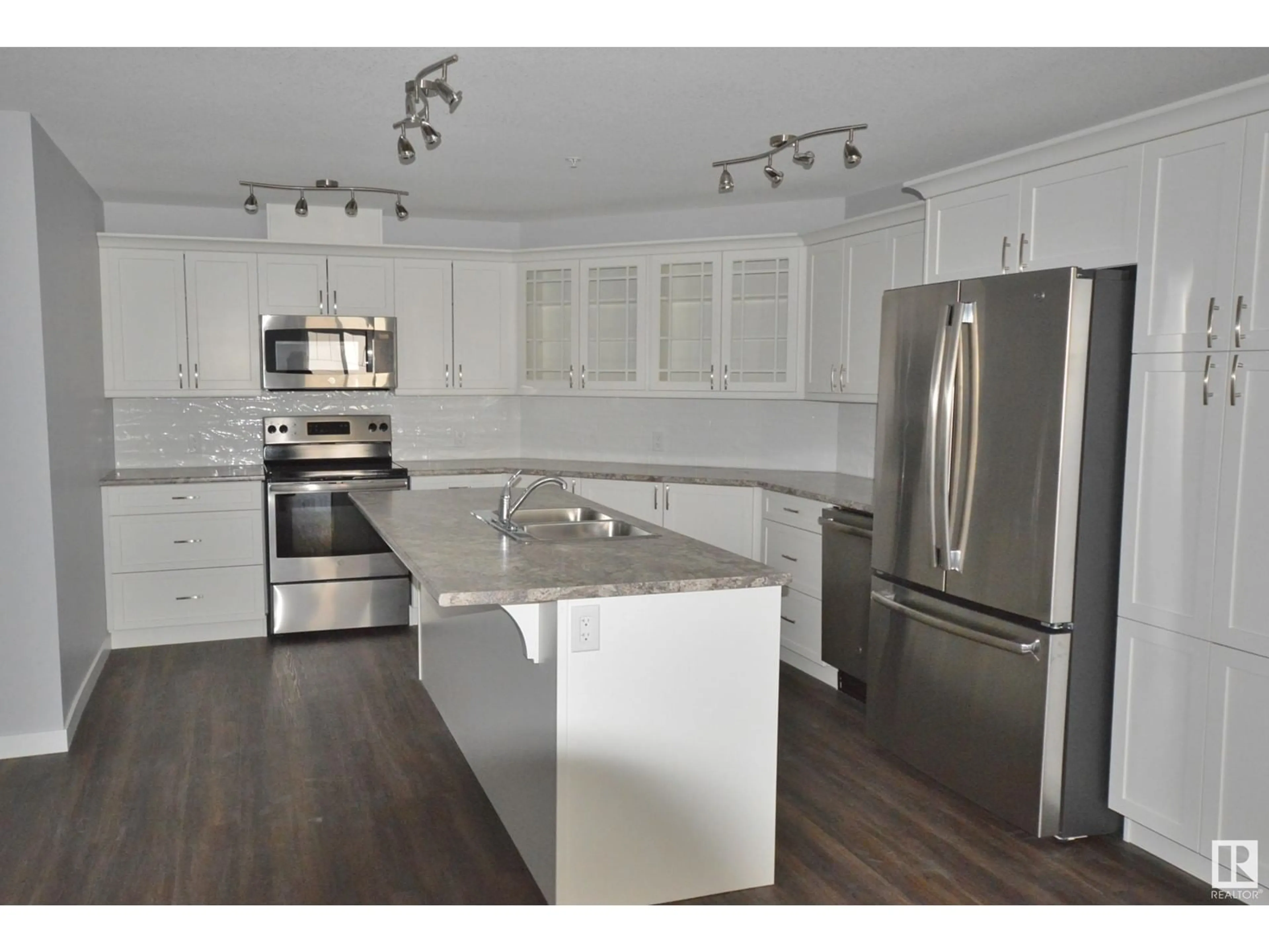 Open concept kitchen, wood/laminate floor for 305 - 4110 43 AV, Bonnyville Town Alberta T9N1S8