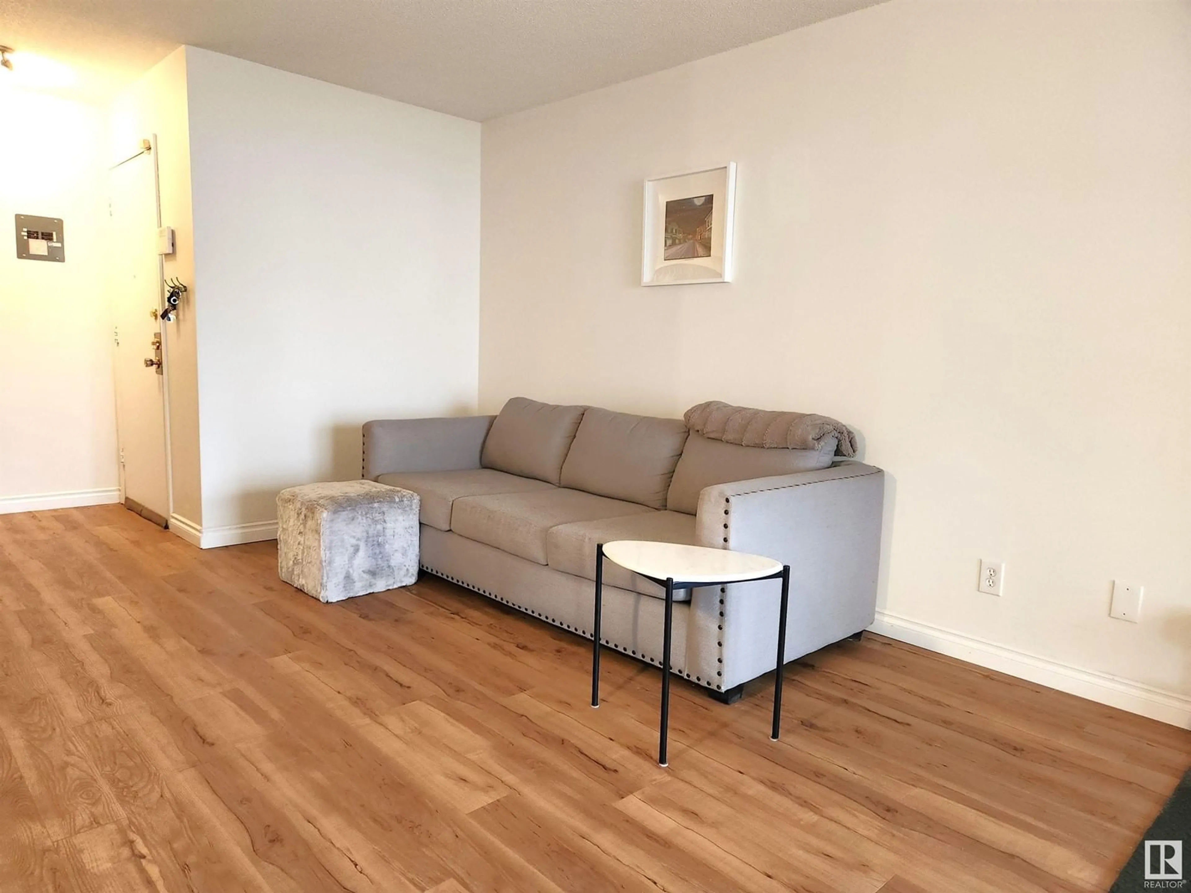Living room with furniture, wood/laminate floor for 209 - 10835 114 ST, Edmonton Alberta T5H3K3