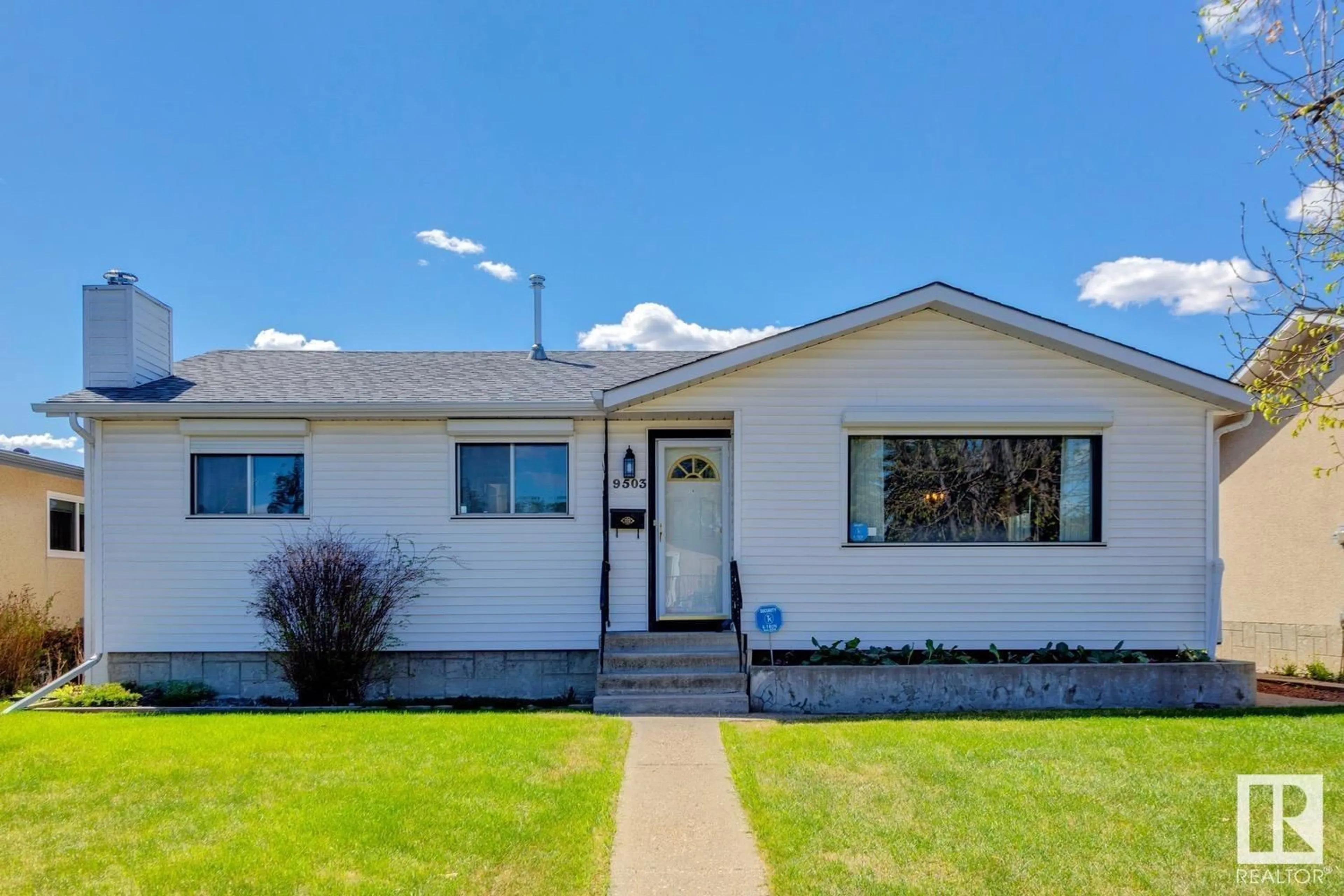 Home with vinyl exterior material, street for 9503 145 AV, Edmonton Alberta T5E2J5