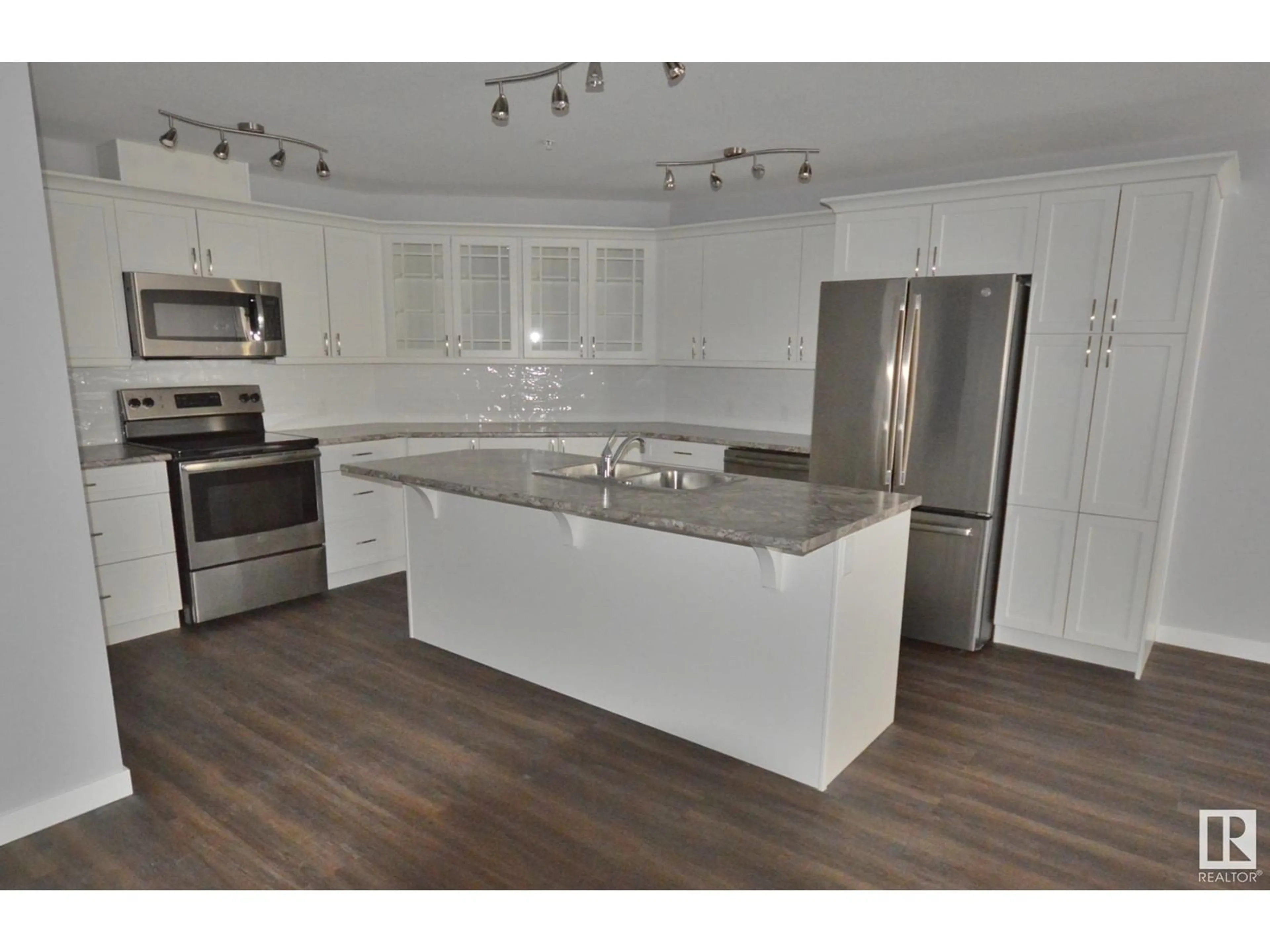 Open concept kitchen, wood/laminate floor for 205 - 4110 43 AV, Bonnyville Town Alberta T9N1S8