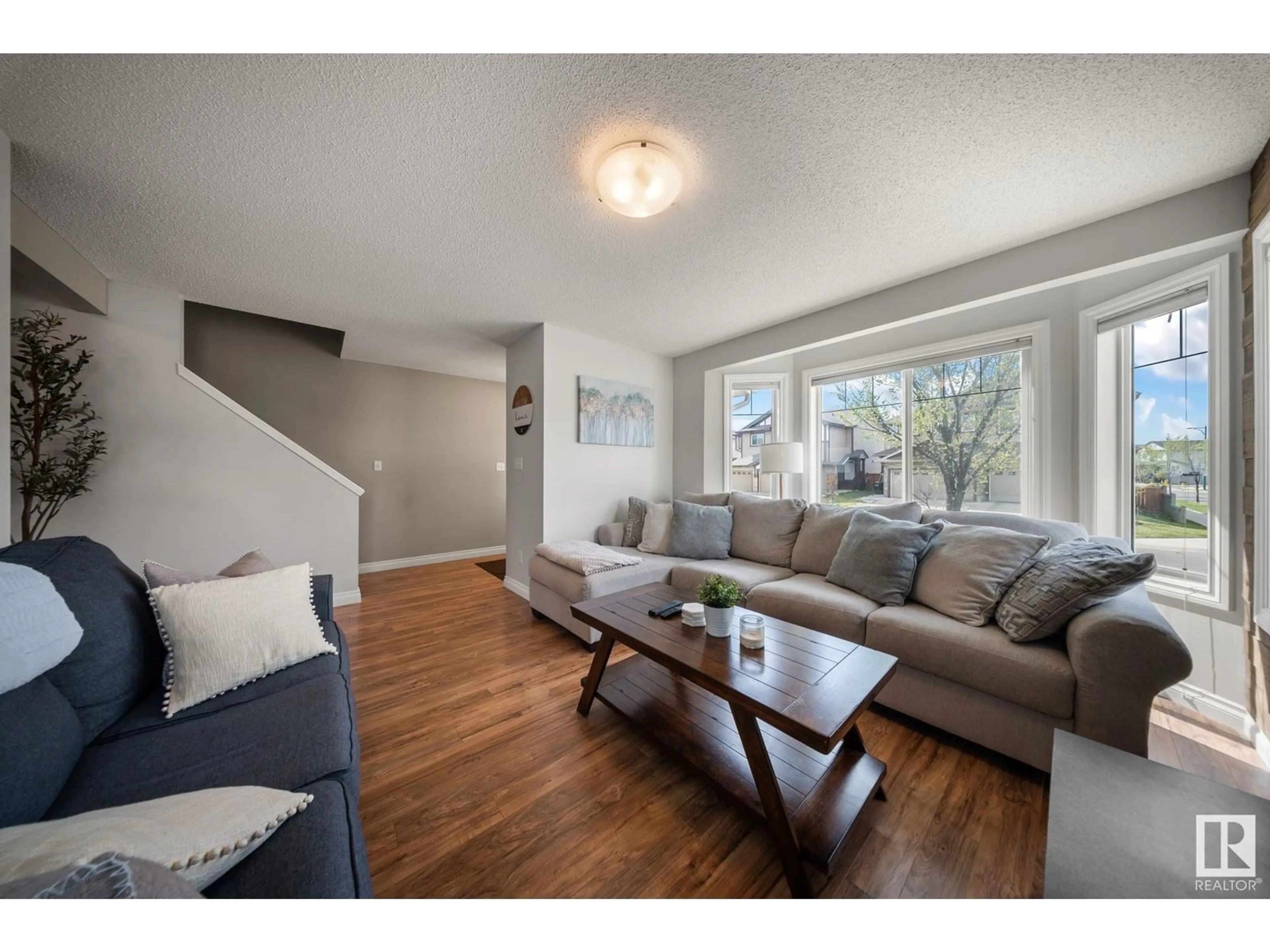 Living room with furniture, wood/laminate floor for 3118 15 AV NW, Edmonton Alberta T6T0V2