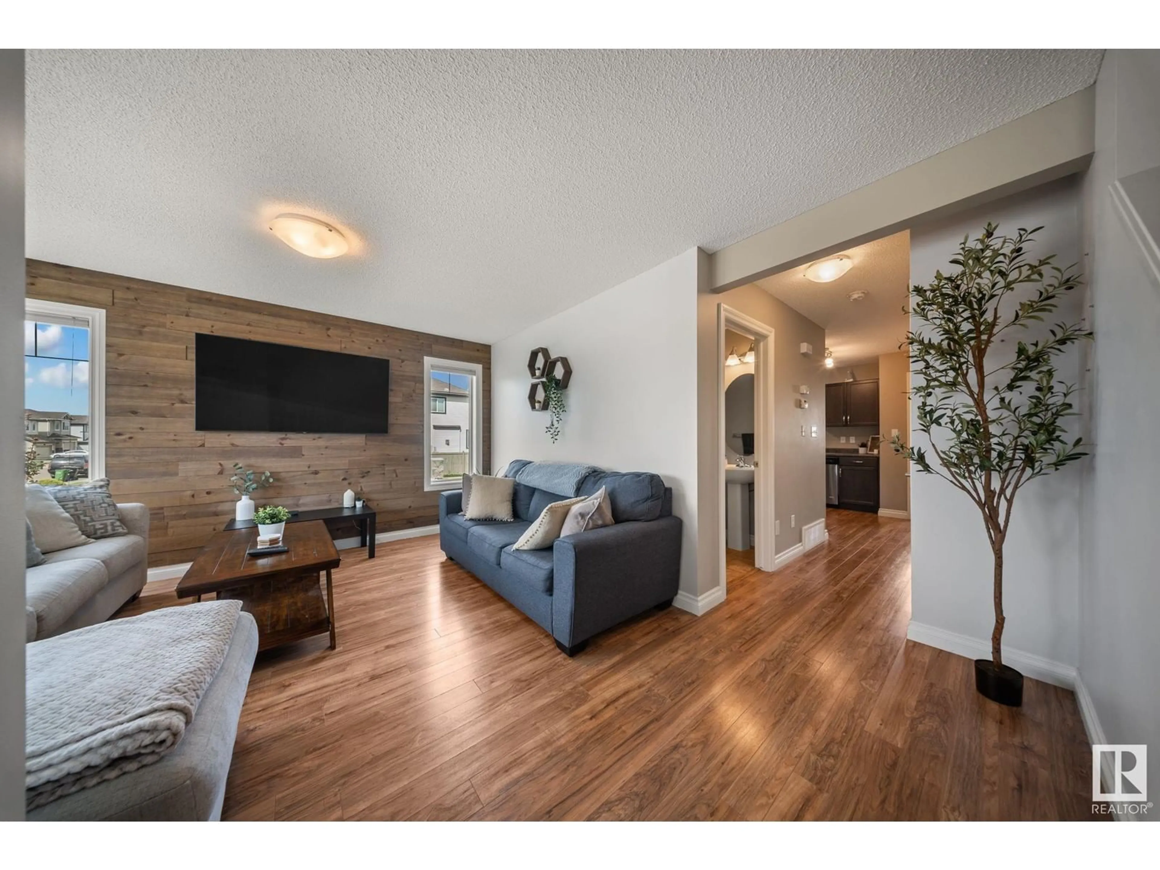 Living room with furniture, wood/laminate floor for 3118 15 AV NW, Edmonton Alberta T6T0V2