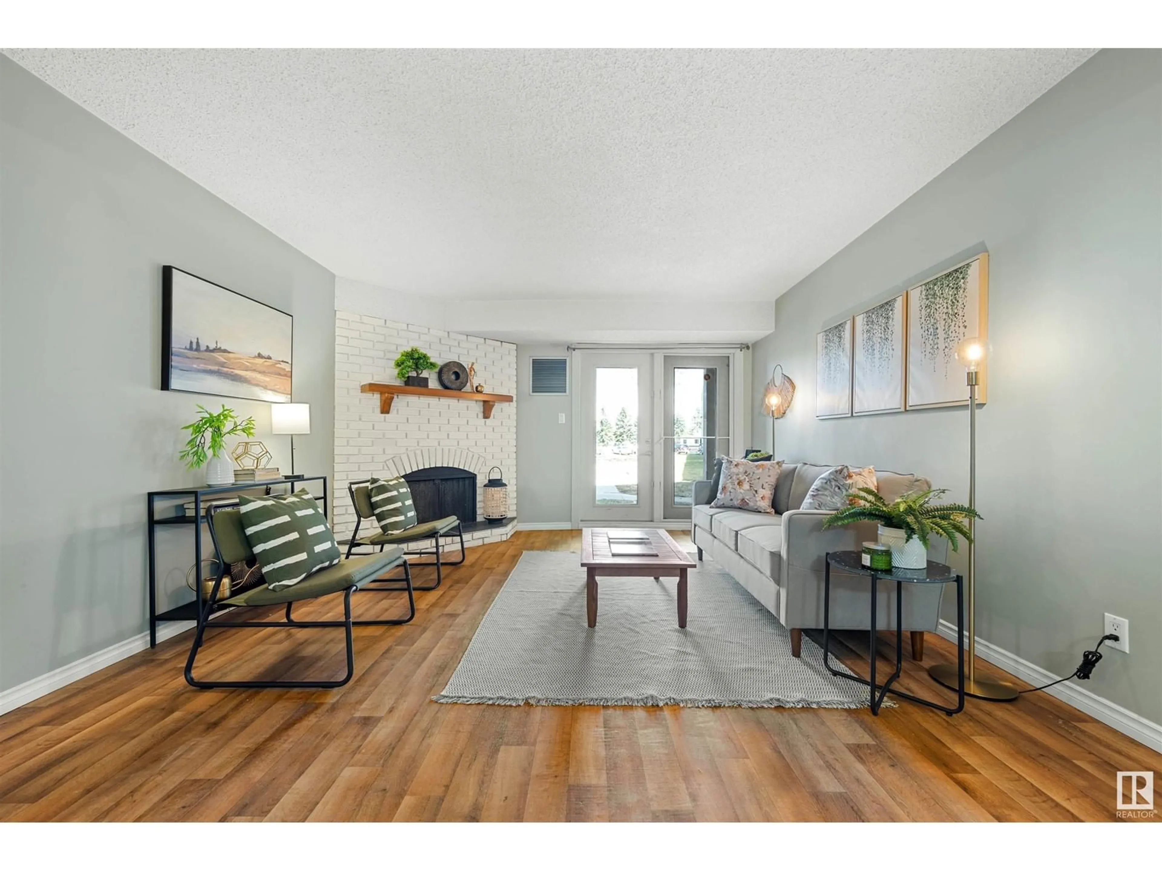 Living room with furniture, wood/laminate floor for #103 - 10524 29 AV, Edmonton Alberta T6J4J2