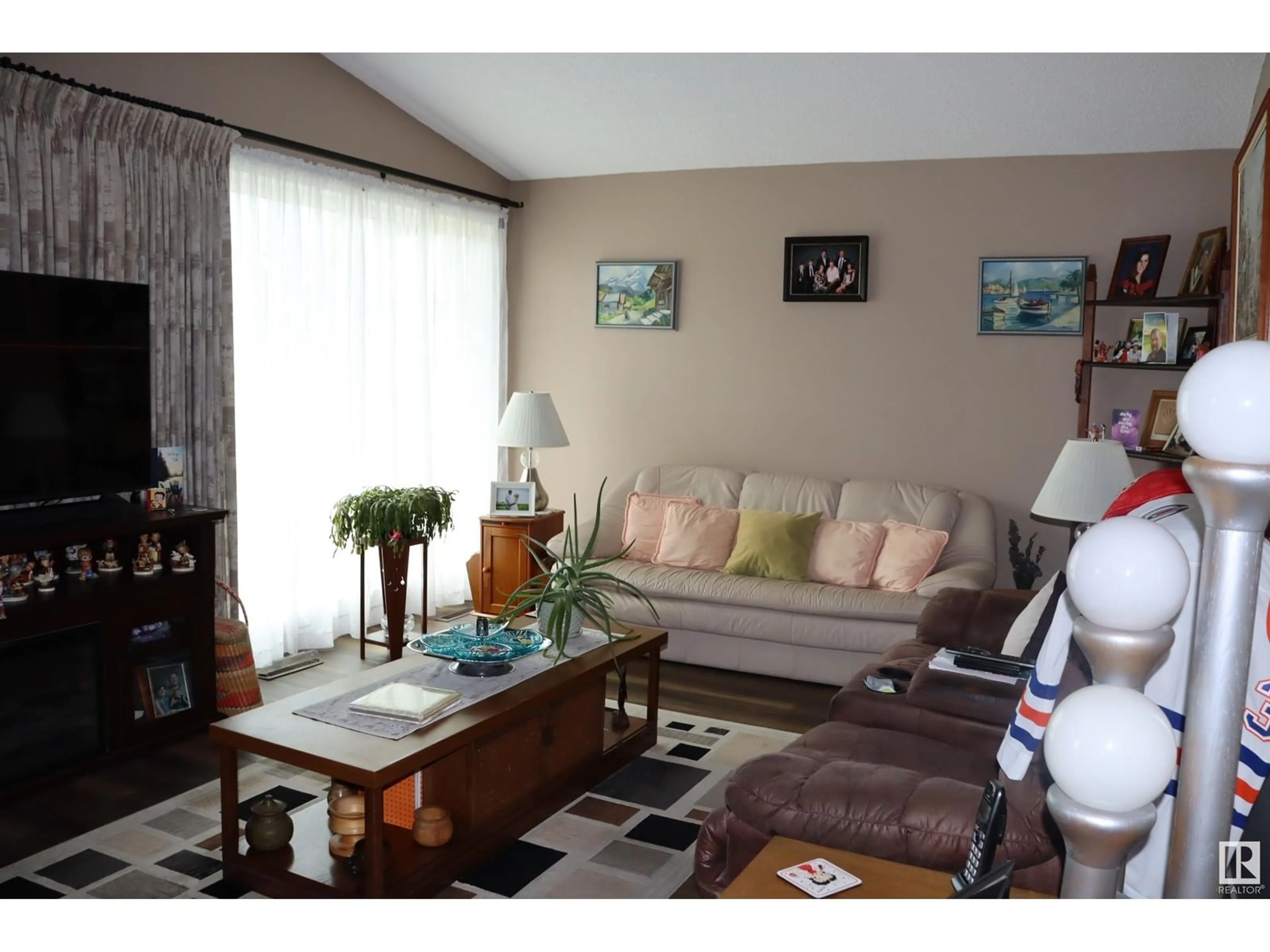 Living room with furniture, wood/laminate floor for 5408 50 AVE, Wetaskiwin Alberta T9A0T2