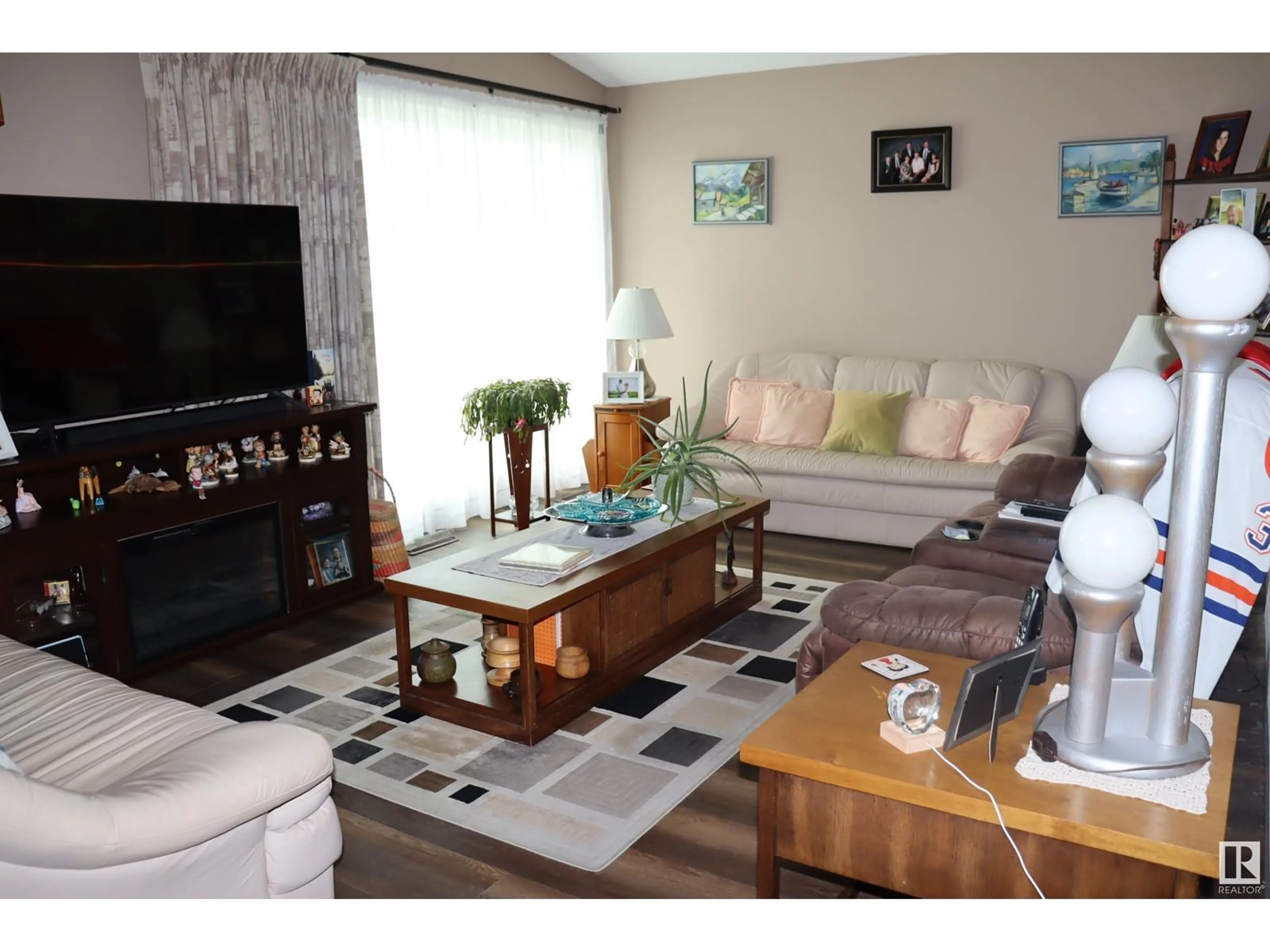 Living room with furniture, wood/laminate floor for 5408 50 AVE, Wetaskiwin Alberta T9A0T2