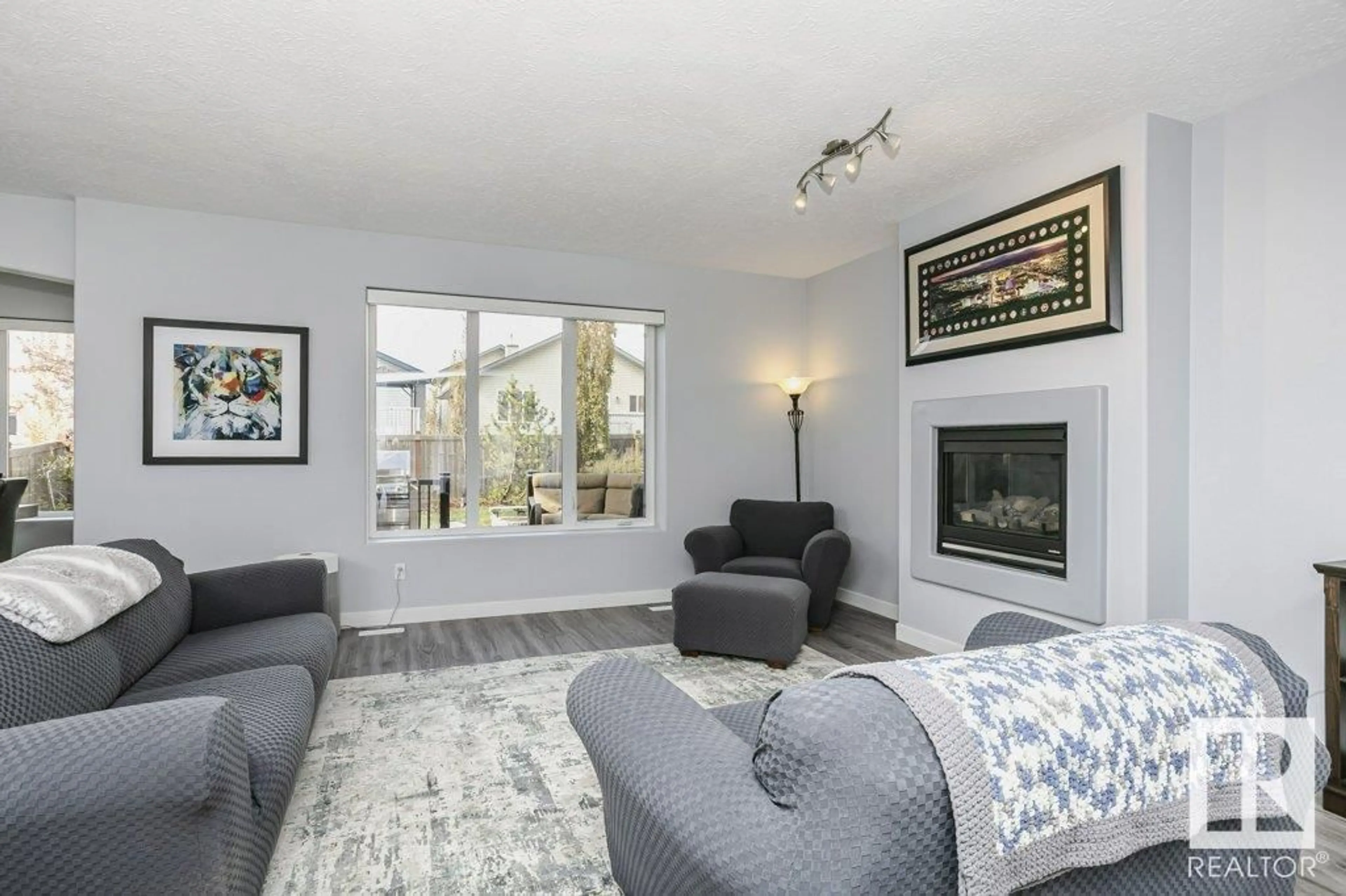 Living room with furniture, unknown for NW - 4713 161 AV, Edmonton Alberta T5Y0H2