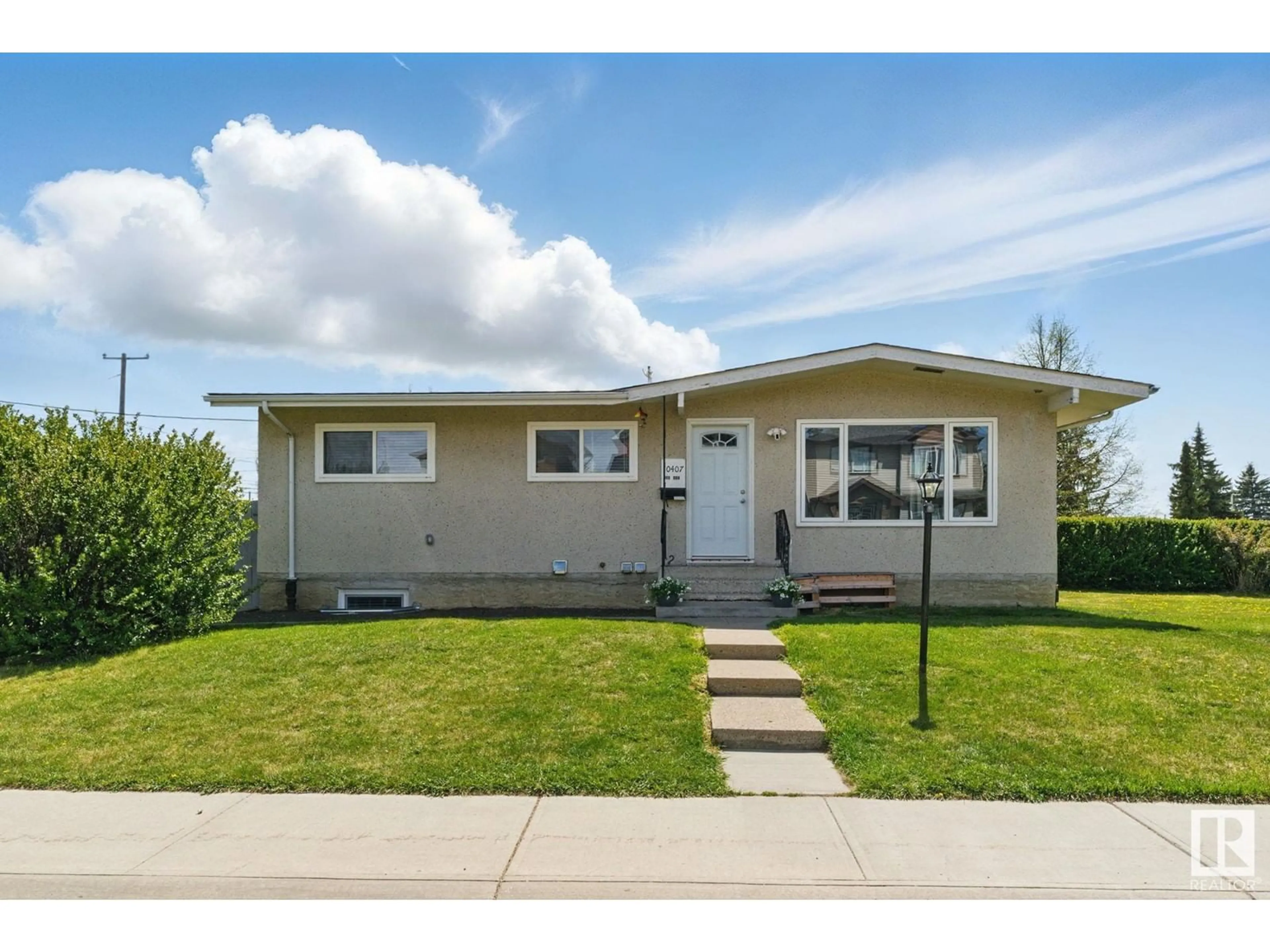 Home with vinyl exterior material, street for NW - 10407 136 AVE, Edmonton Alberta T5E1W2