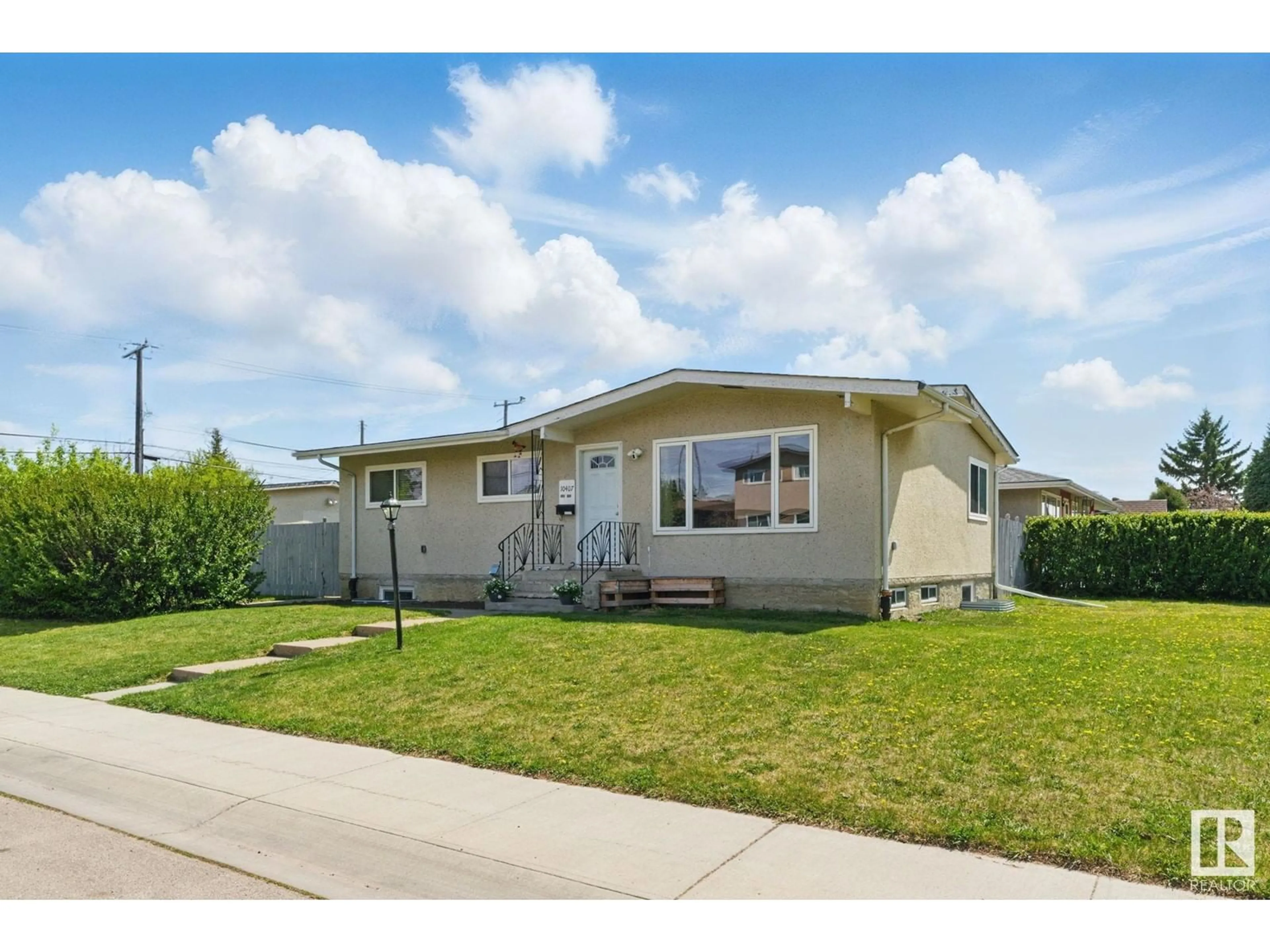 Home with vinyl exterior material, street for NW - 10407 136 AVE, Edmonton Alberta T5E1W2