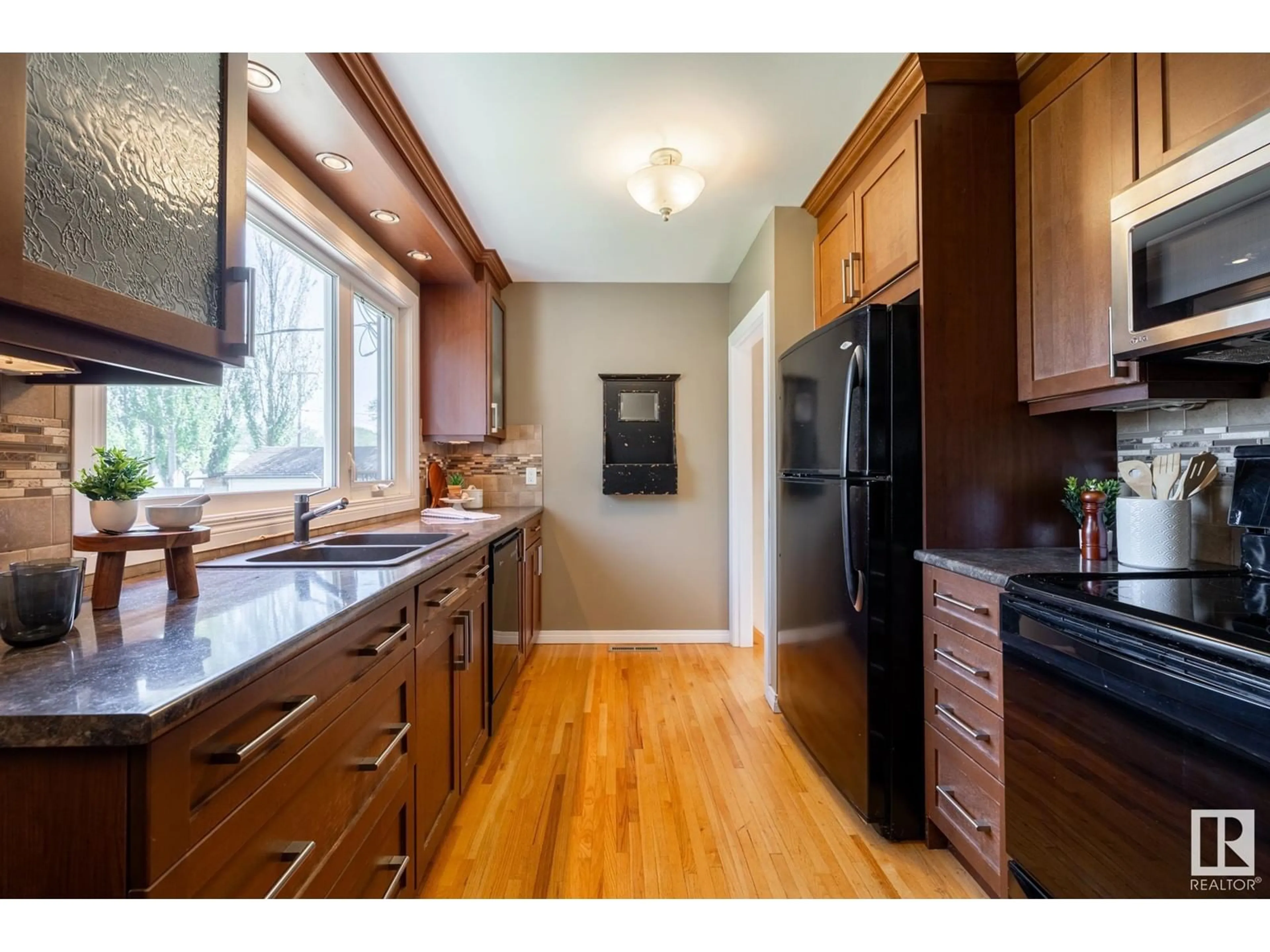 Open concept kitchen, wood/laminate floor for 12121 39 ST, Edmonton Alberta T5W2J9