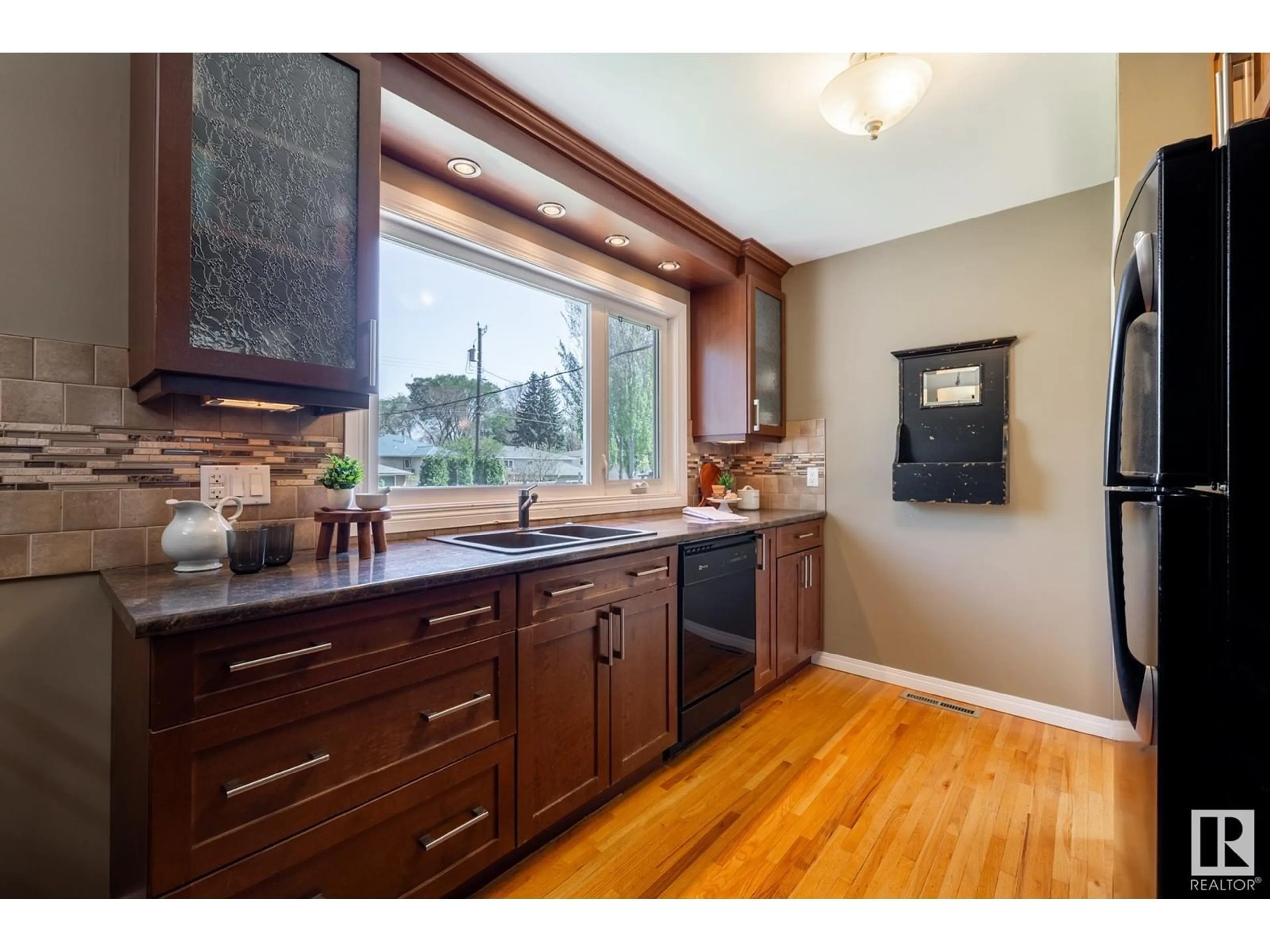 Open concept kitchen, wood/laminate floor for 12121 39 ST, Edmonton Alberta T5W2J9