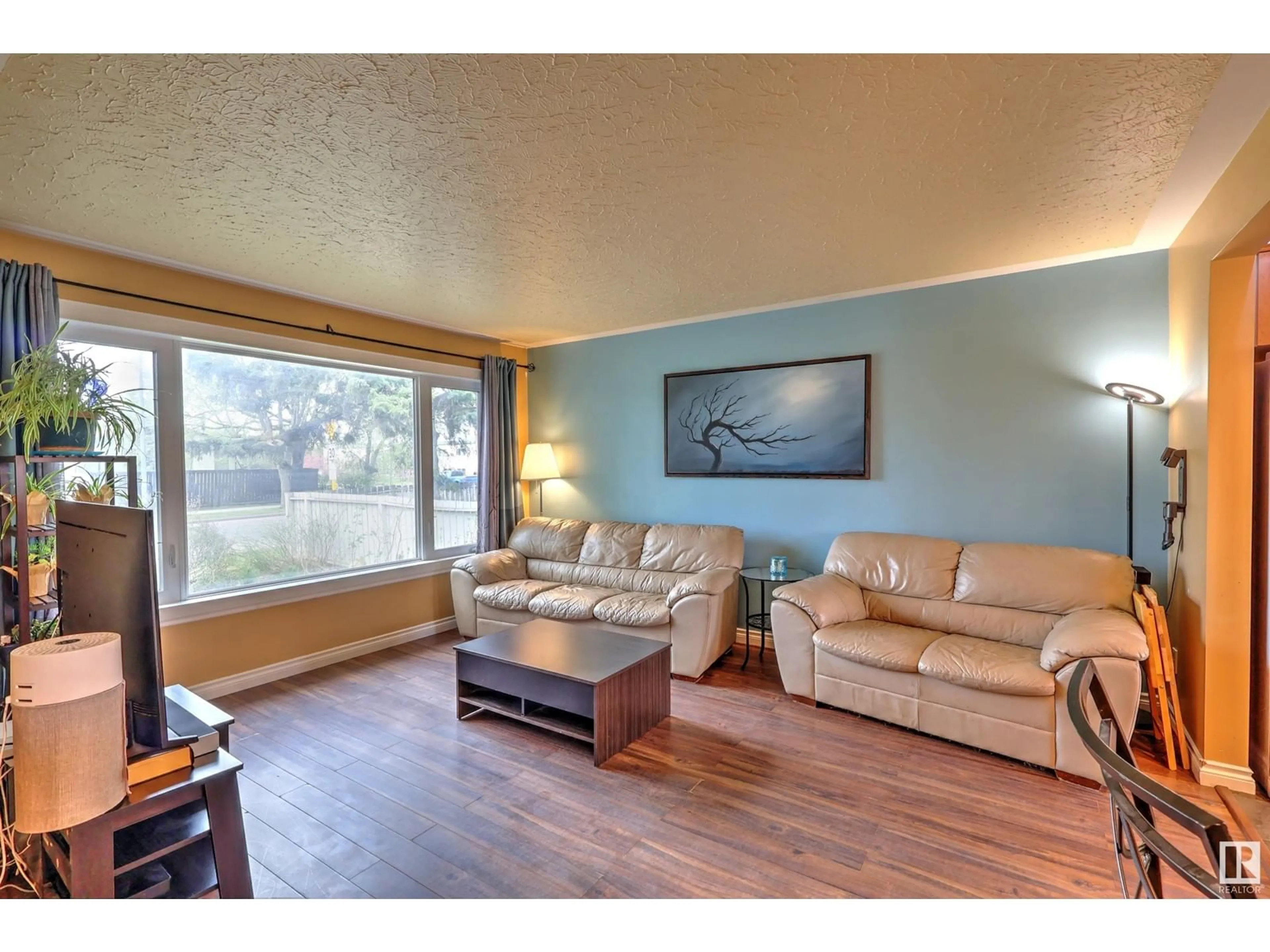 Living room with furniture, wood/laminate floor for 15640 92 AV, Edmonton Alberta T5R5C4