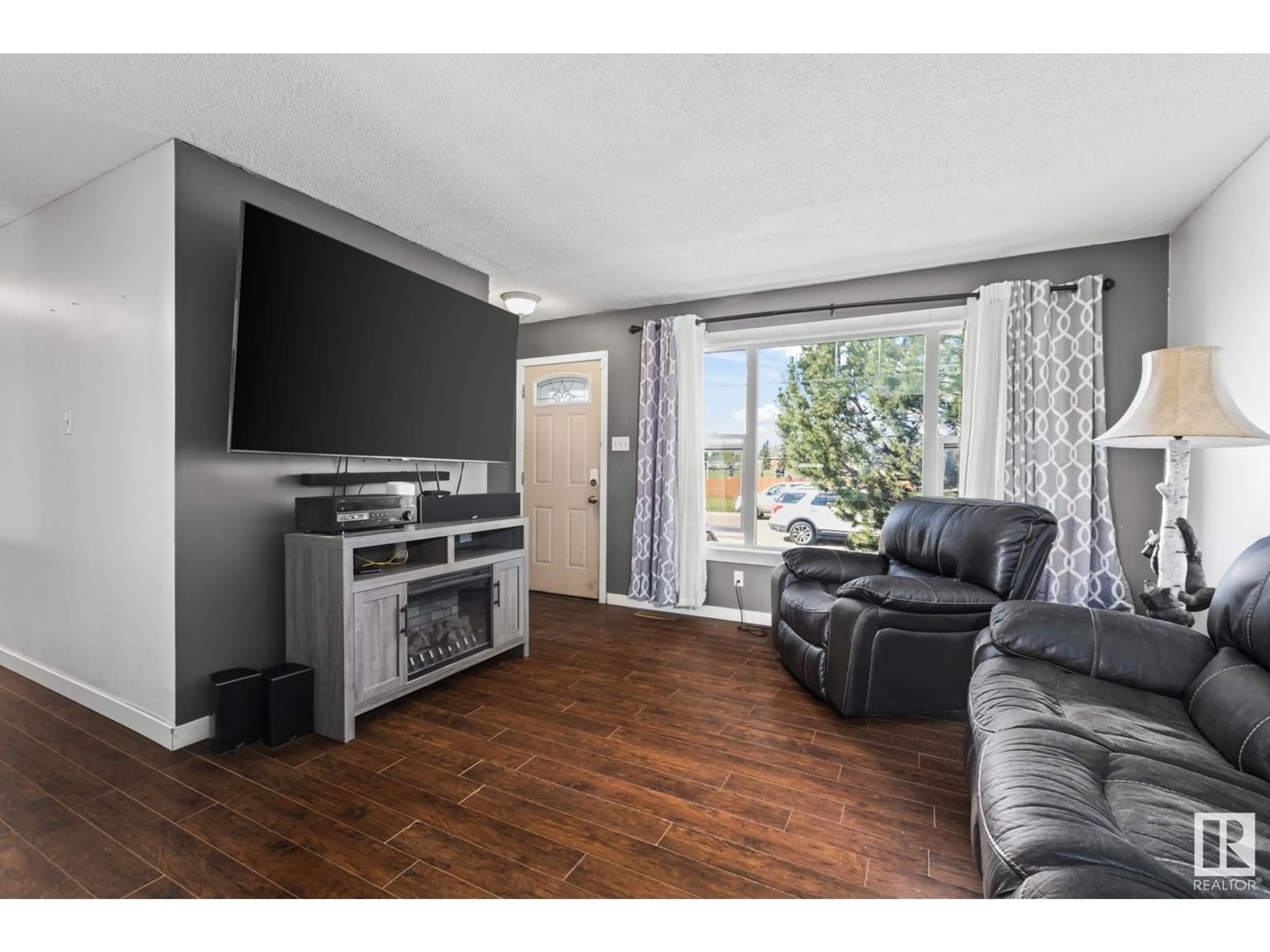 Living room with furniture, wood/laminate floor for 7111 130A AV, Edmonton Alberta T5C1Y8