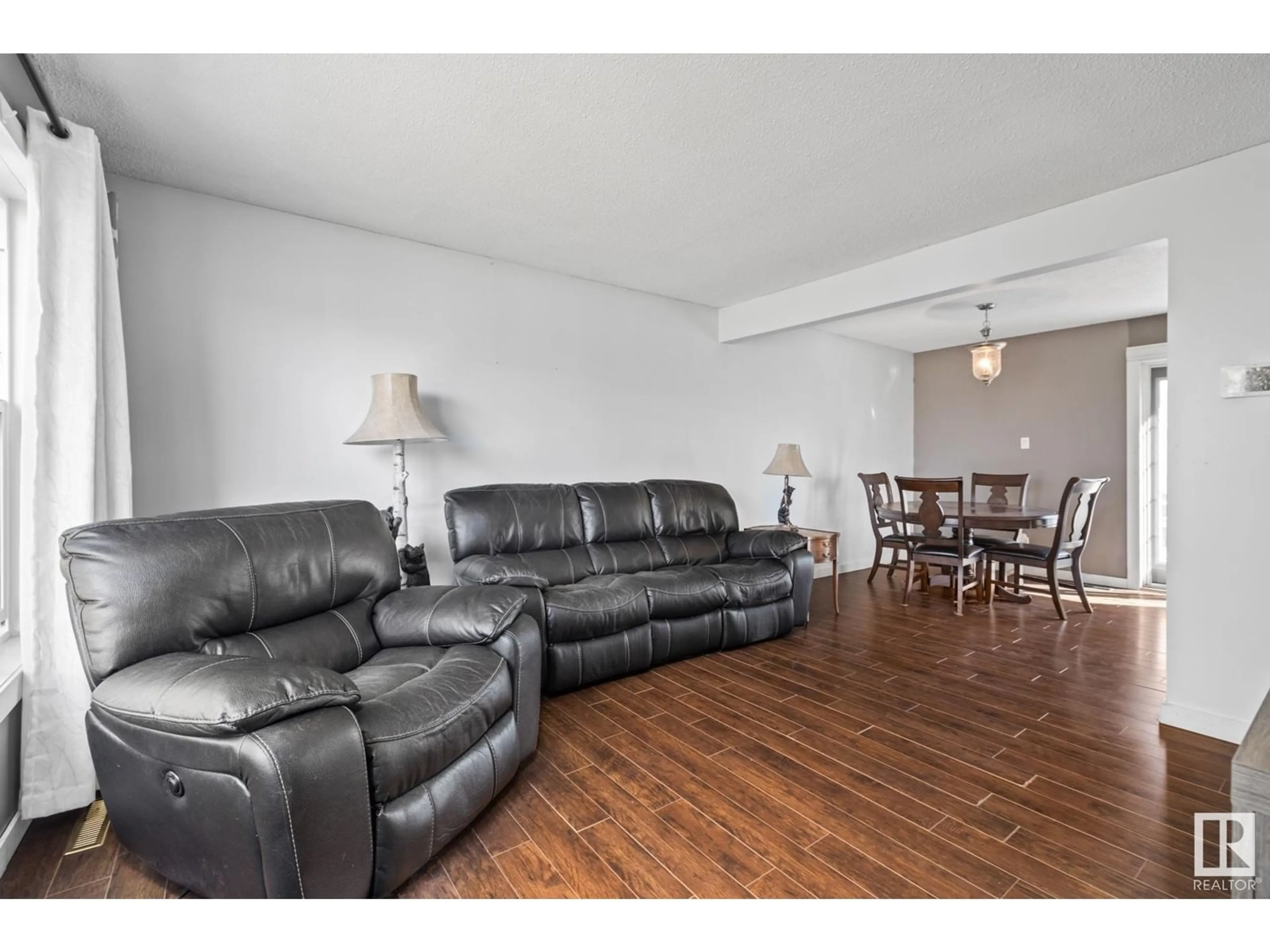 Living room with furniture, wood/laminate floor for 7111 130A AV, Edmonton Alberta T5C1Y8