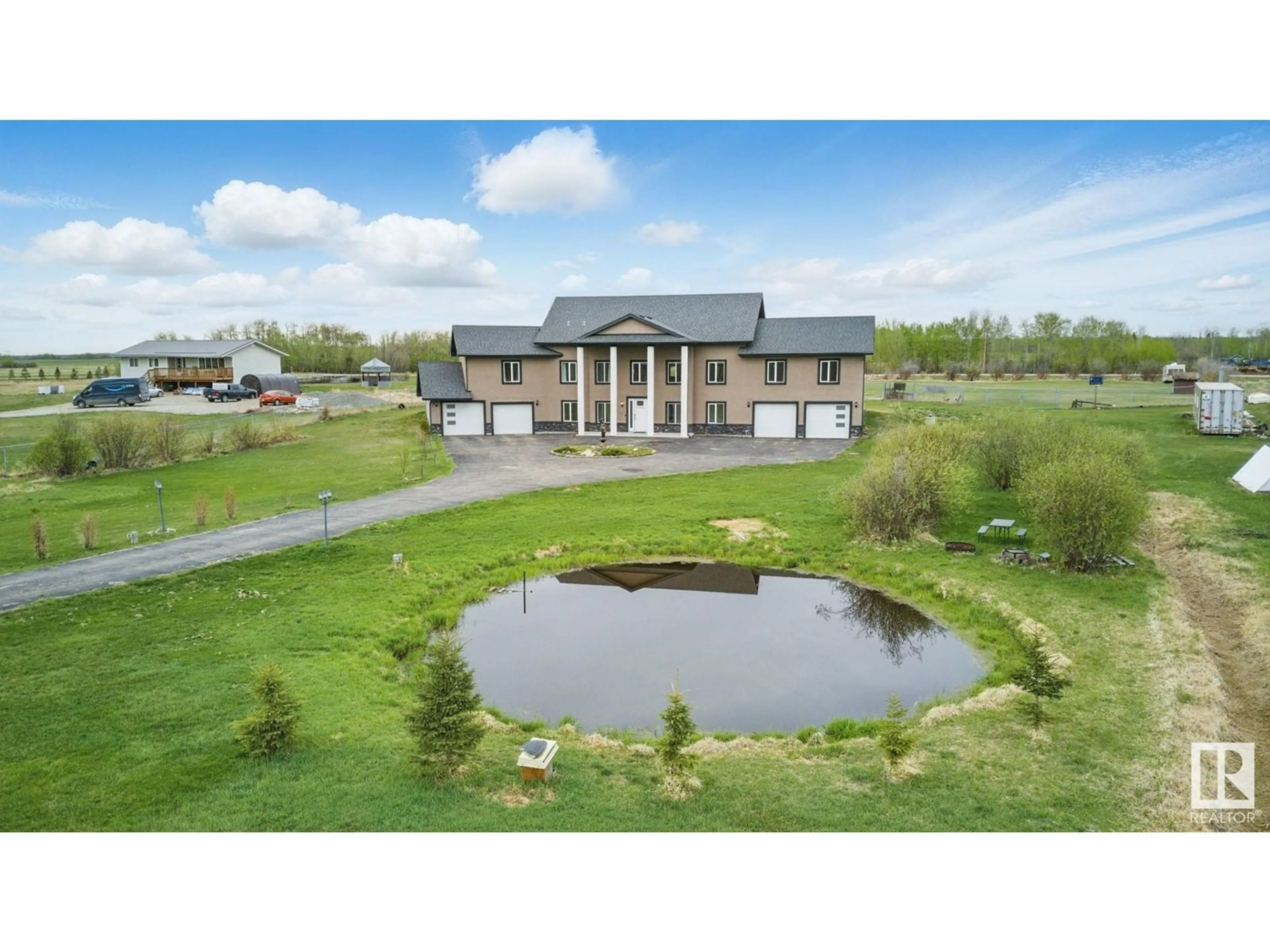 A pic from outside/outdoor area/front of a property/back of a property/a pic from drone, water/lake/river/ocean view for 390 50353 RGE RD 224, Rural Leduc County Alberta T0B3M1
