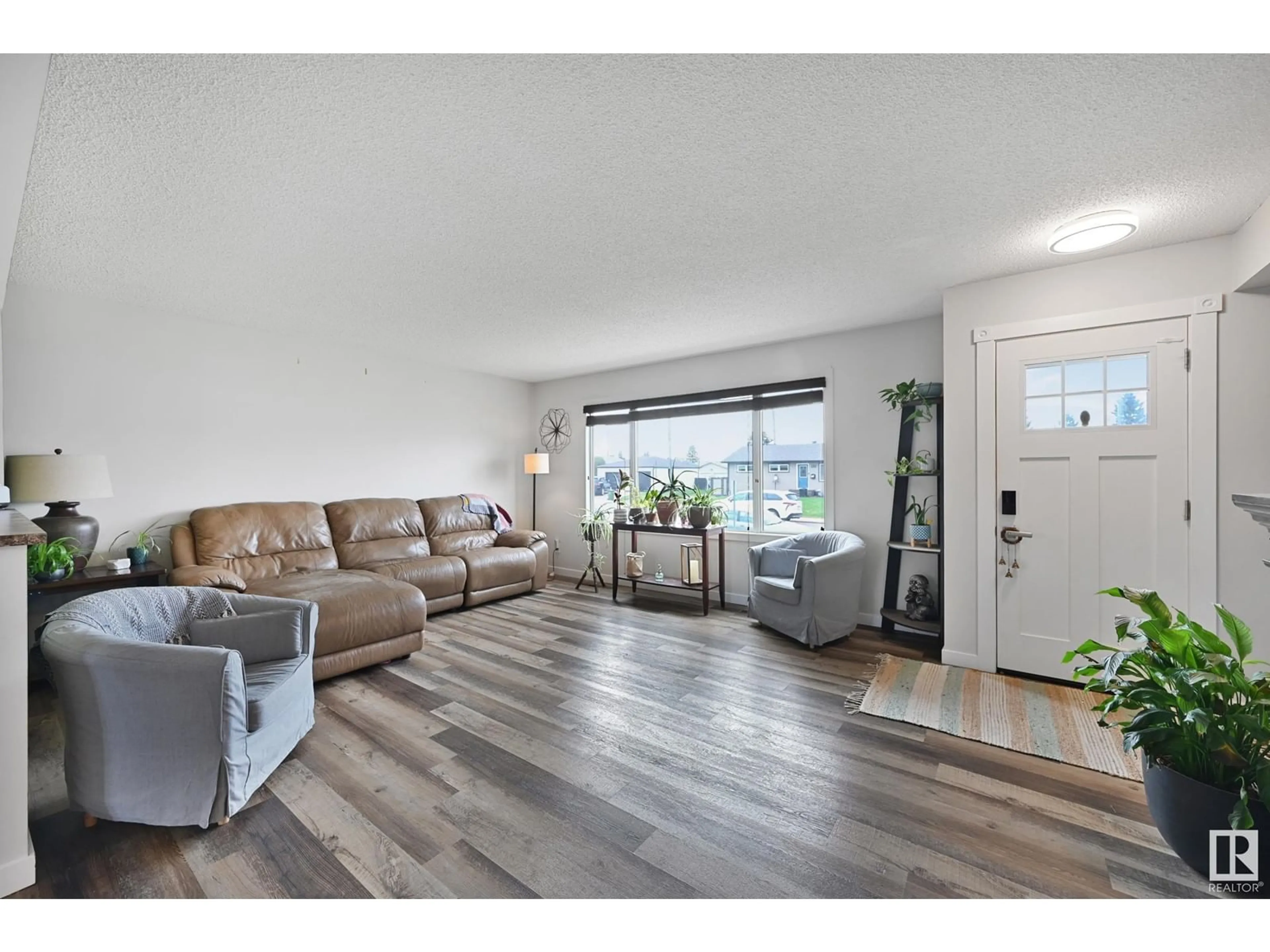 Living room with furniture, wood/laminate floor for 7820 130 AV, Edmonton Alberta T5C1V5