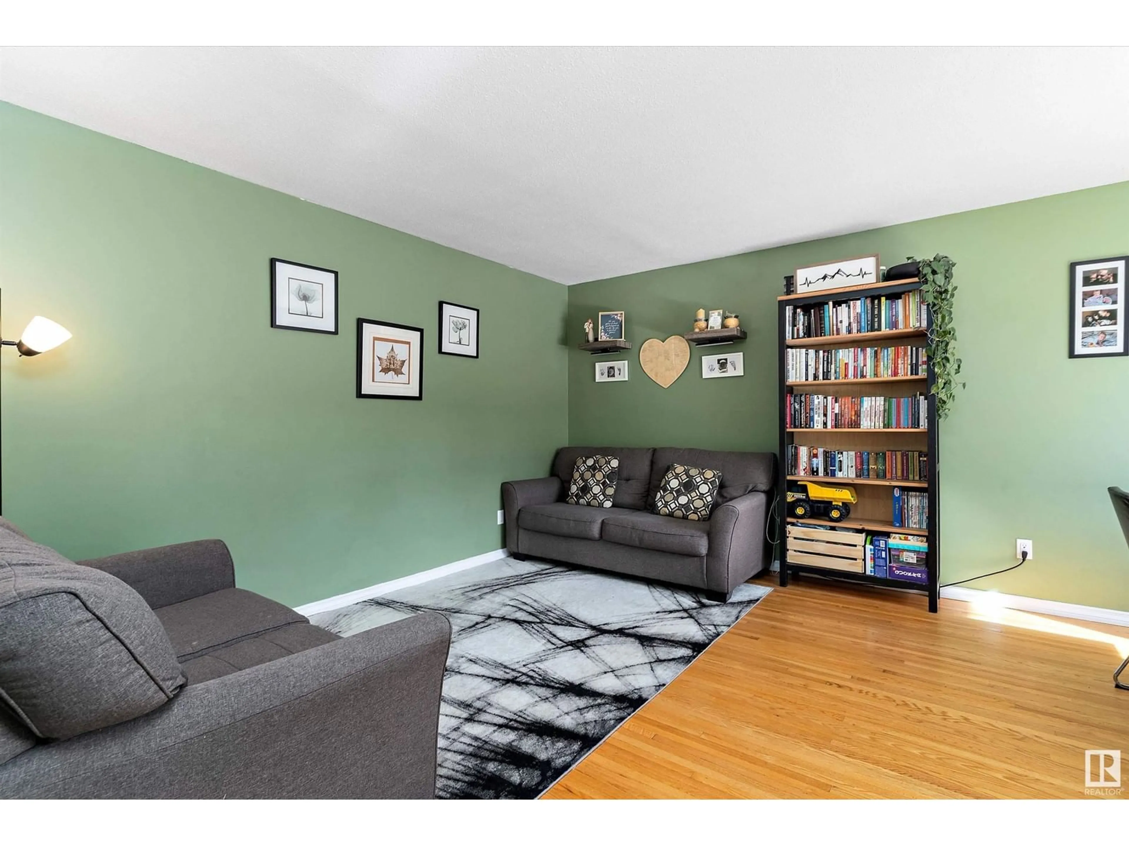 Living room with furniture, wood/laminate floor for 127 LONDONDERRY SQUARE, Edmonton Alberta T5C3C4