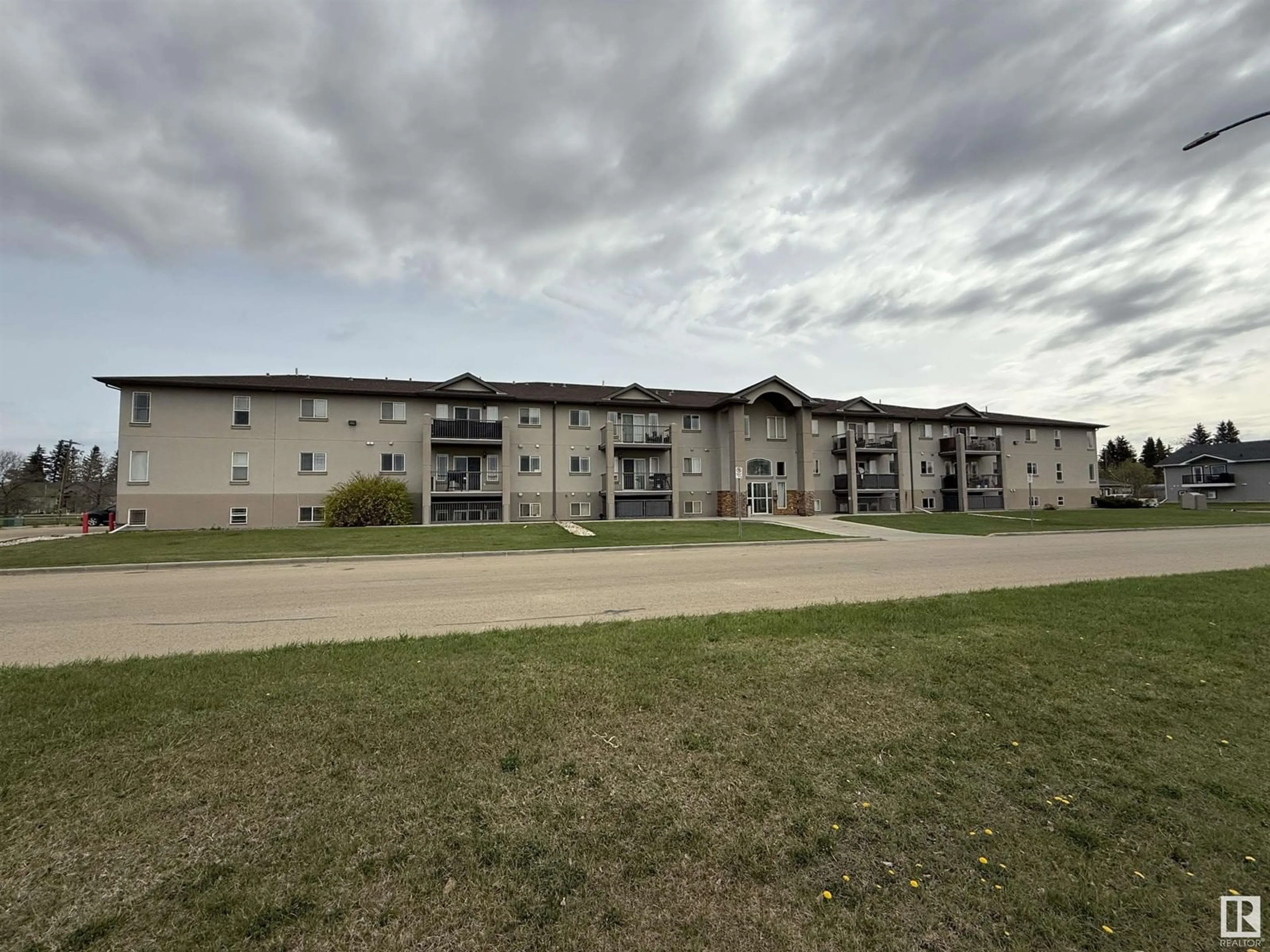 A pic from outside/outdoor area/front of a property/back of a property/a pic from drone, building for 210 - 5204 52 AV, Tofield Alberta T0B4J0