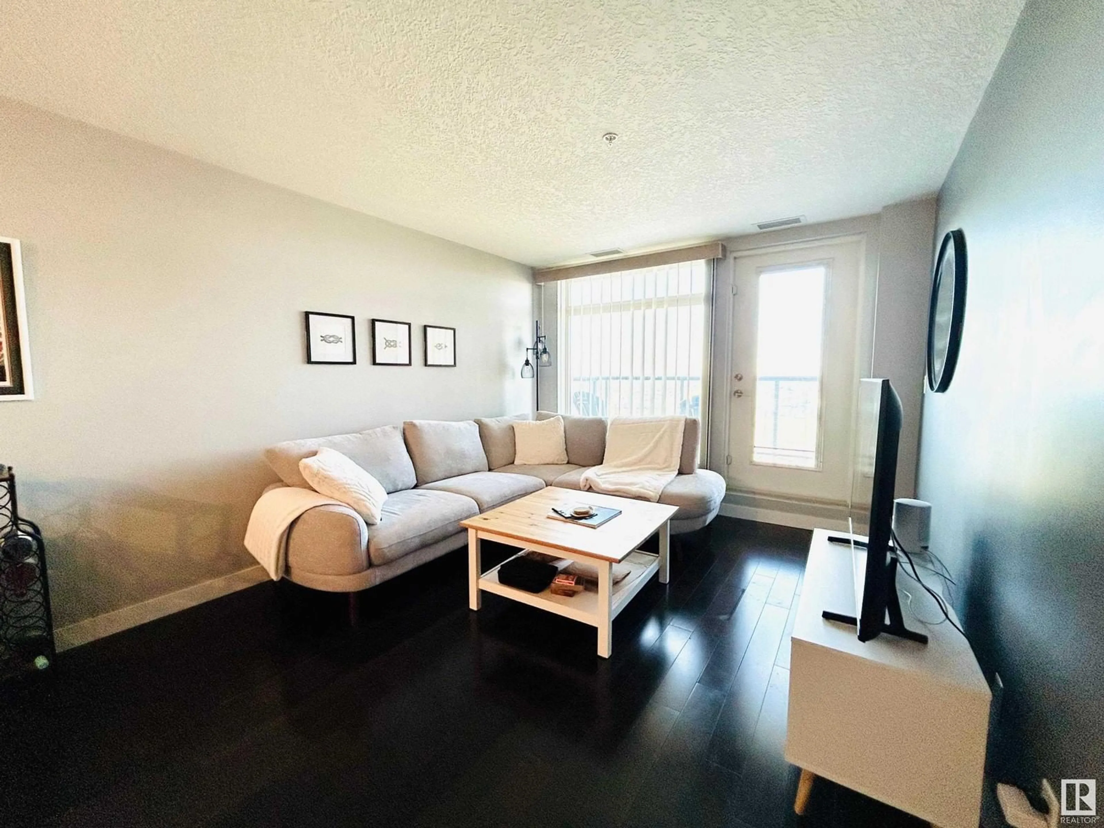 Living room with furniture, wood/laminate floor for 5151 - 925 WINDERMERE BV, Edmonton Alberta T6W2K4