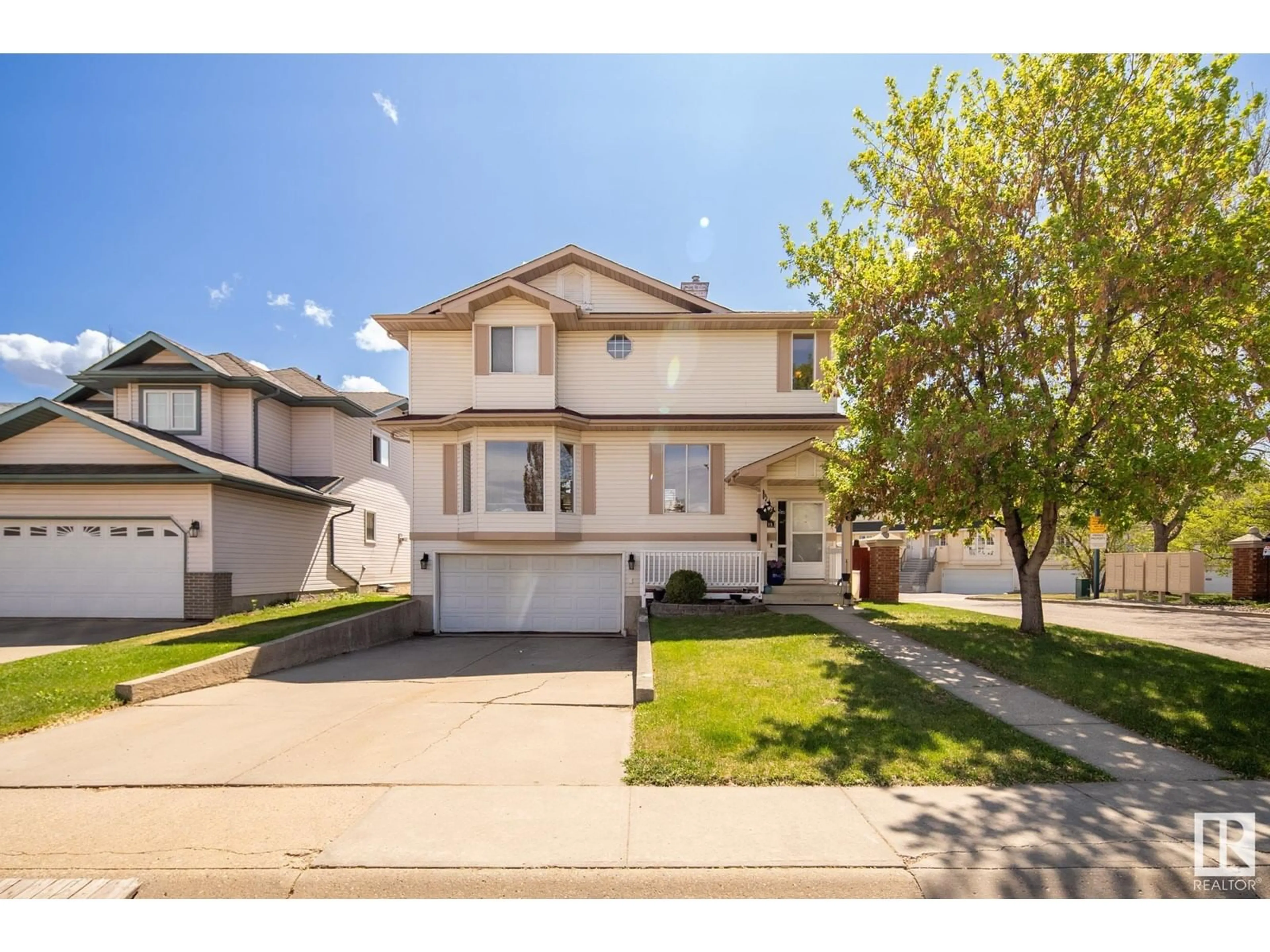 Home with vinyl exterior material, street for NW - 2415 133 AV, Edmonton Alberta T5A4Z9