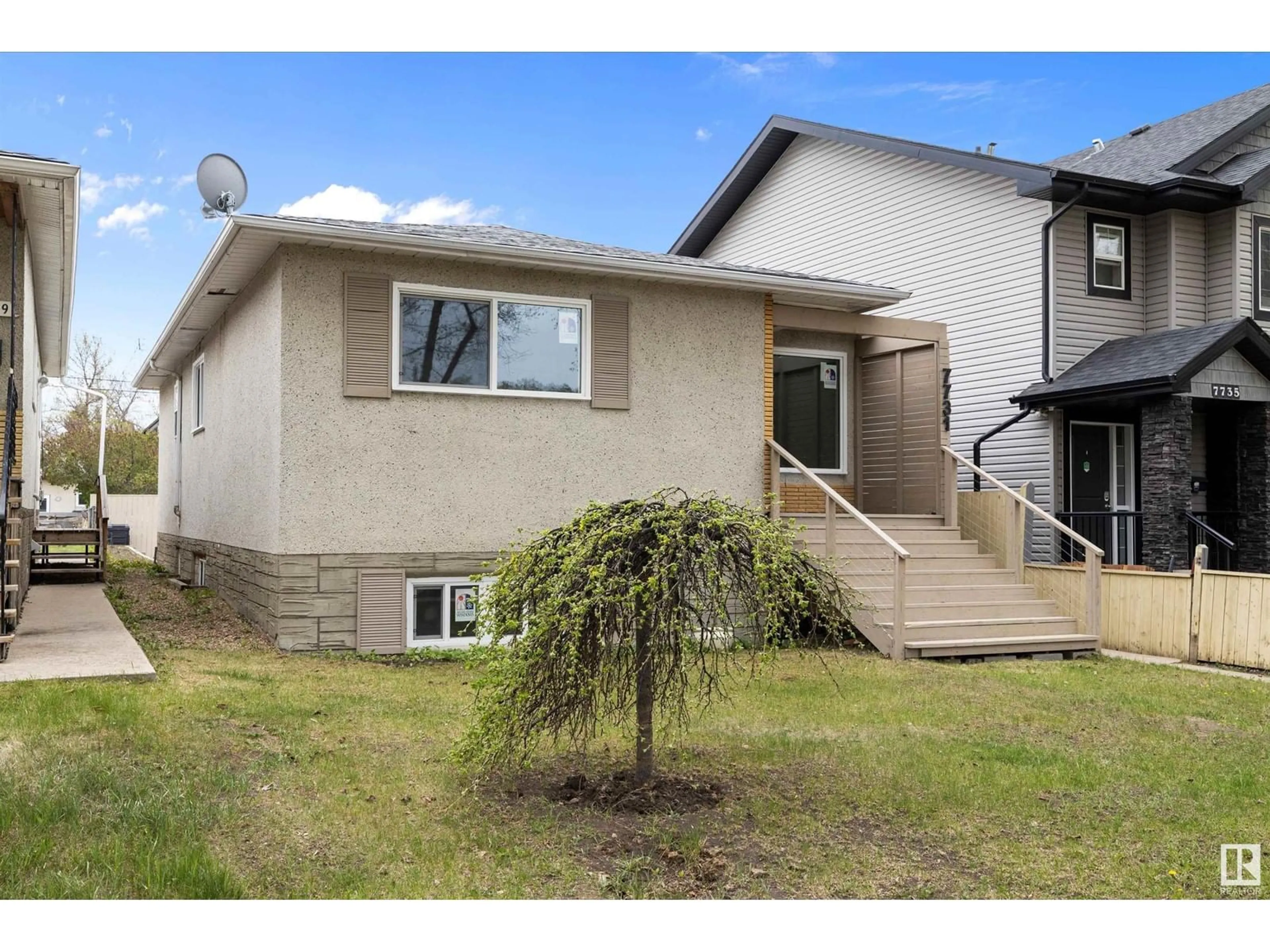 Home with vinyl exterior material, street for 7731 80 AV, Edmonton Alberta T6C0S3