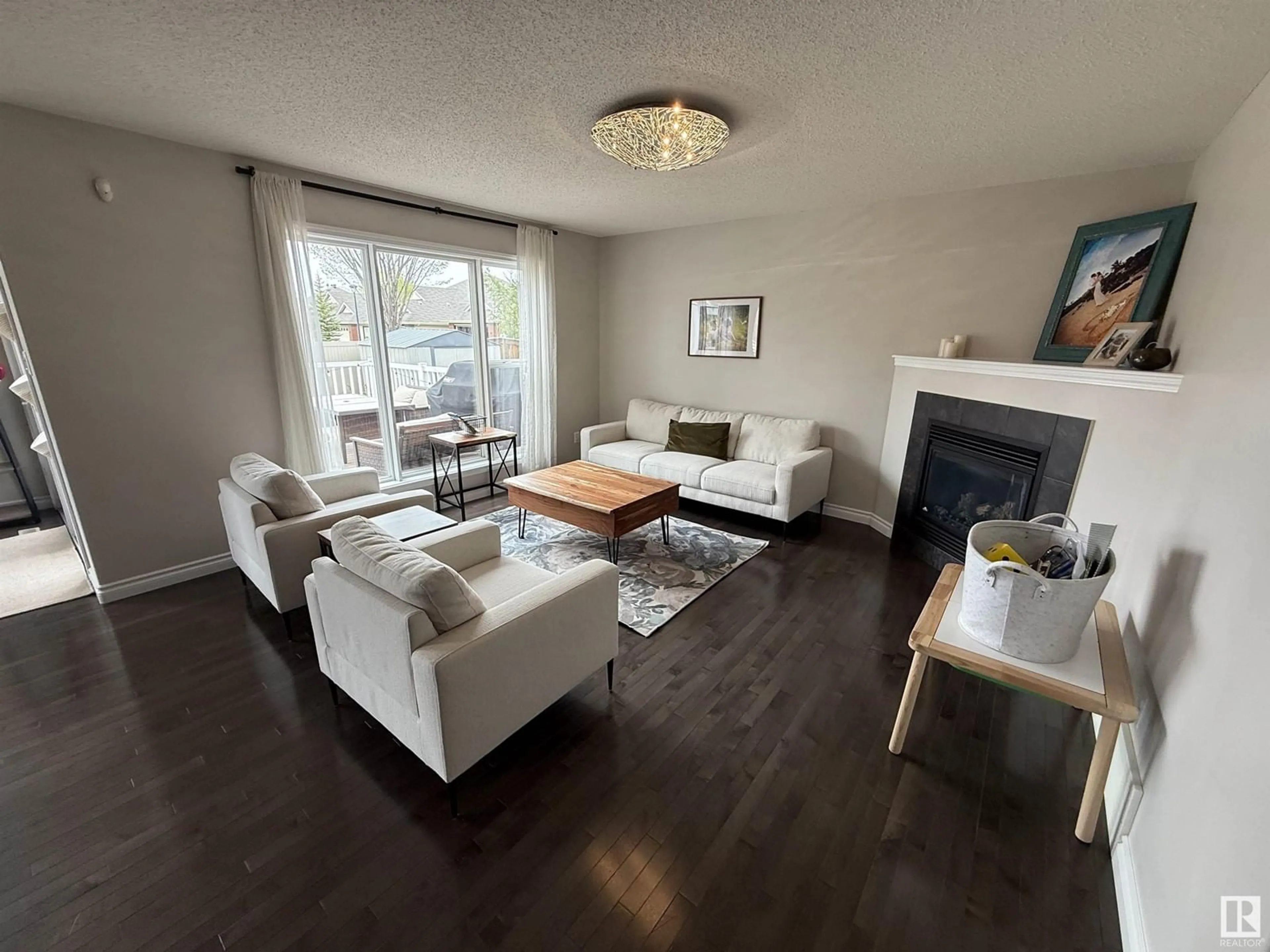 Living room with furniture, wood/laminate floor for 8664 SLOANE CO NW, Edmonton Alberta T6R0K9