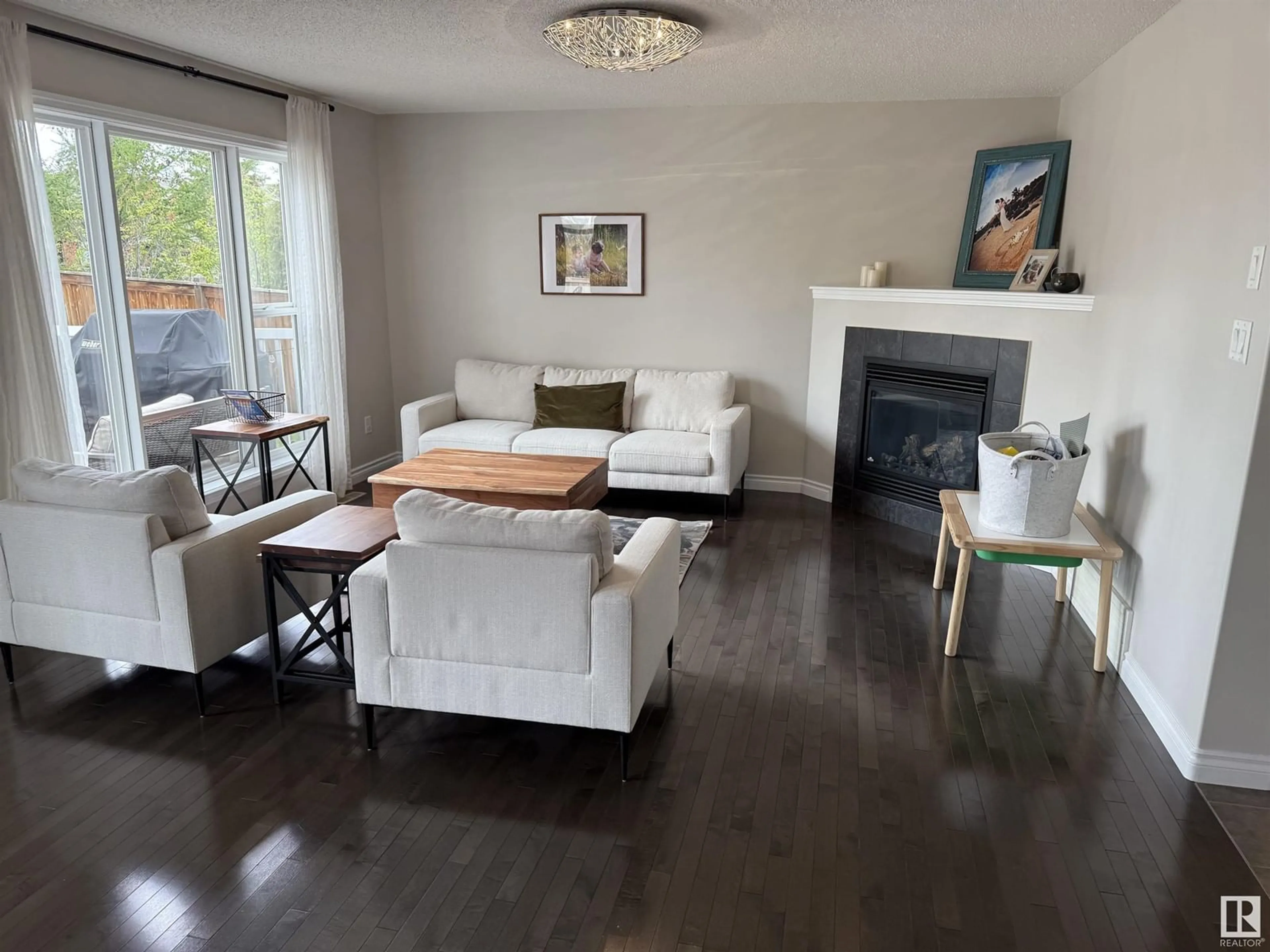 Living room with furniture, wood/laminate floor for 8664 SLOANE CO NW, Edmonton Alberta T6R0K9
