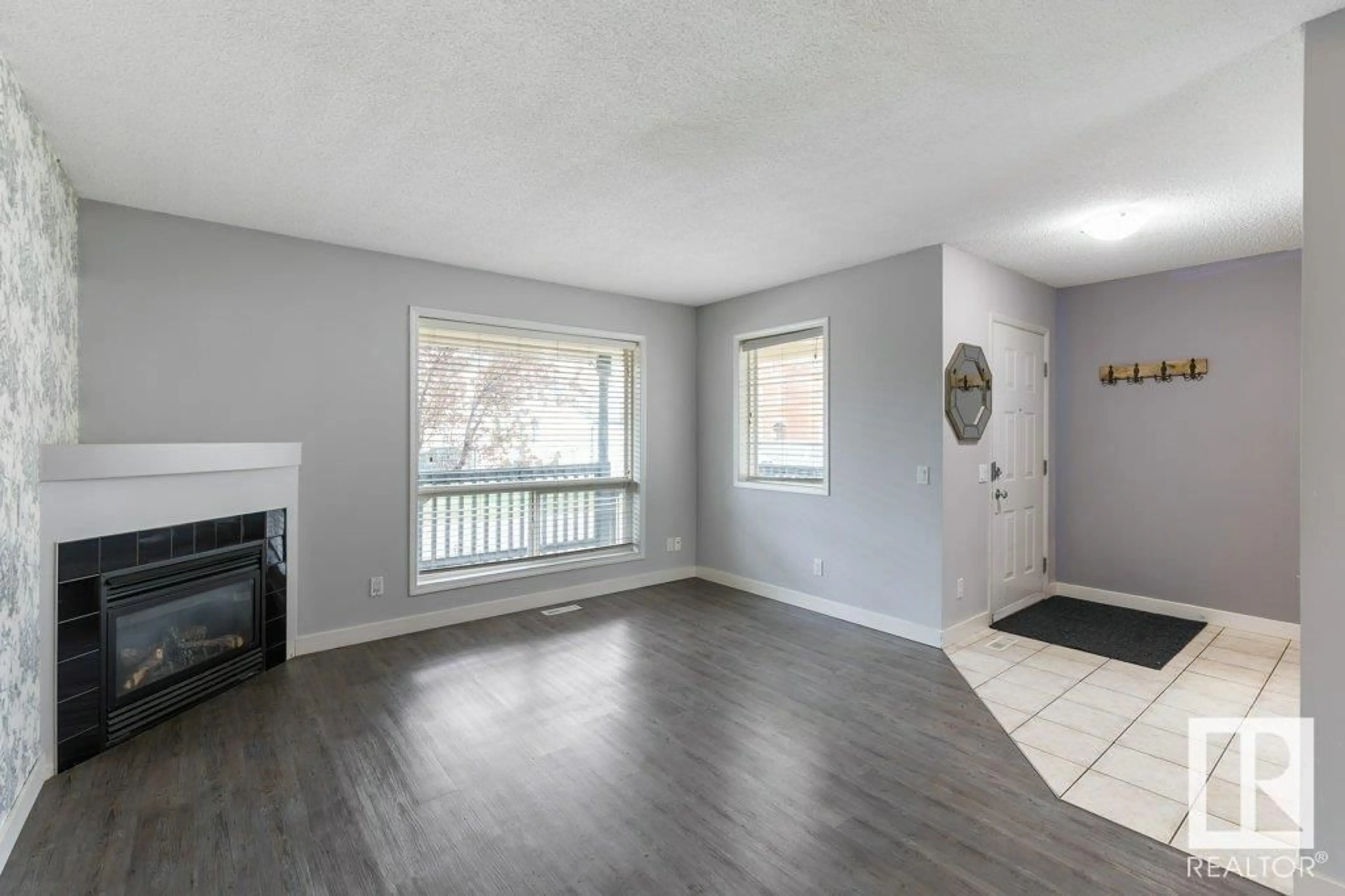 Living room with furniture, wood/laminate floor for 12 10909 106 ST NW, Edmonton Alberta T5H4M7