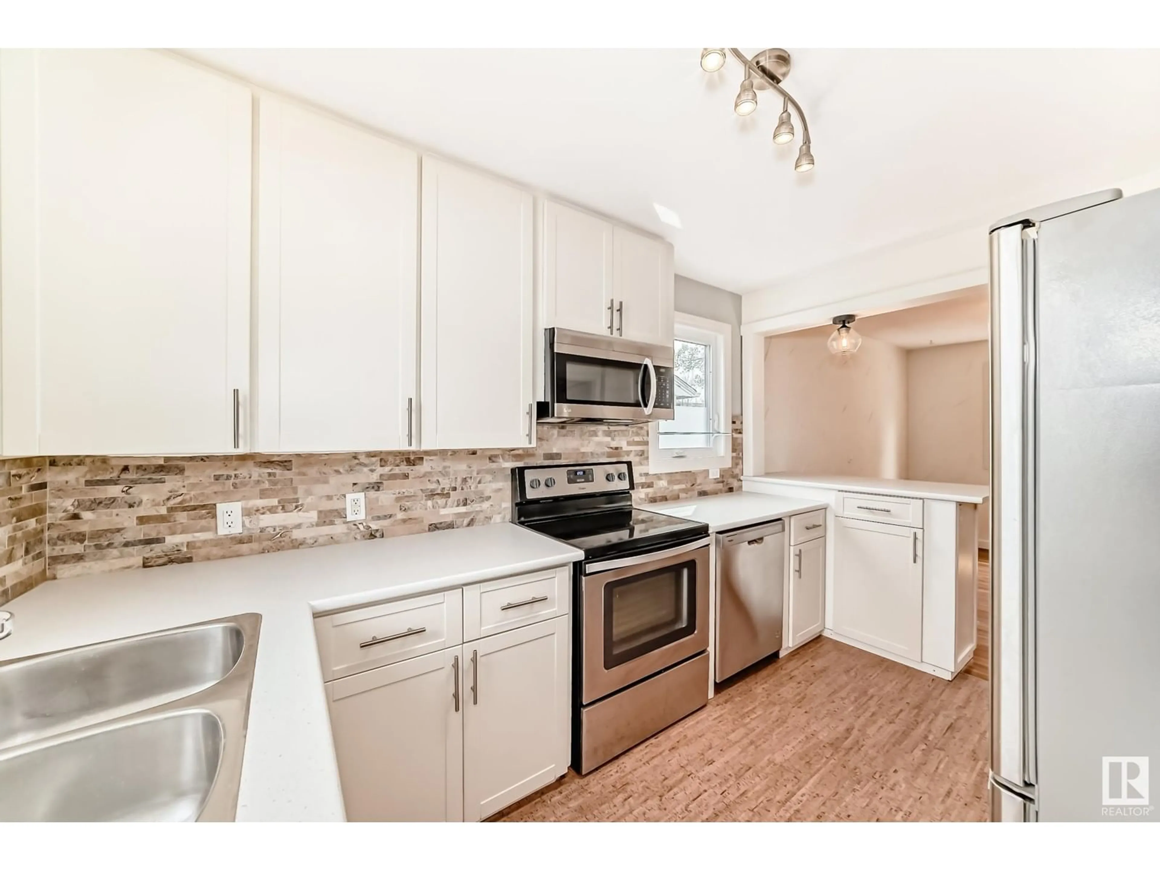 Open concept kitchen, unknown for 7720 77 AV, Edmonton Alberta T6C0K7
