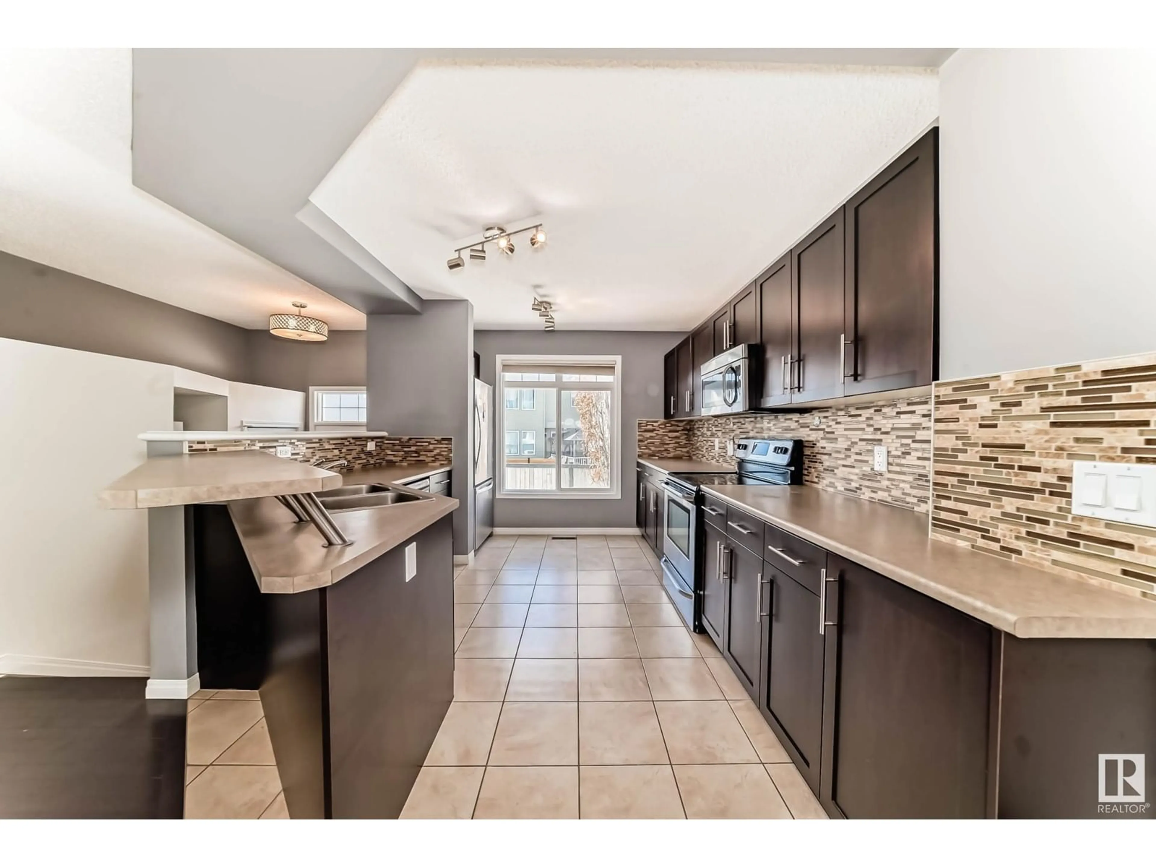 Open concept kitchen, ceramic/tile floor for #104 - 1804 70 ST, Edmonton Alberta T6X0H4